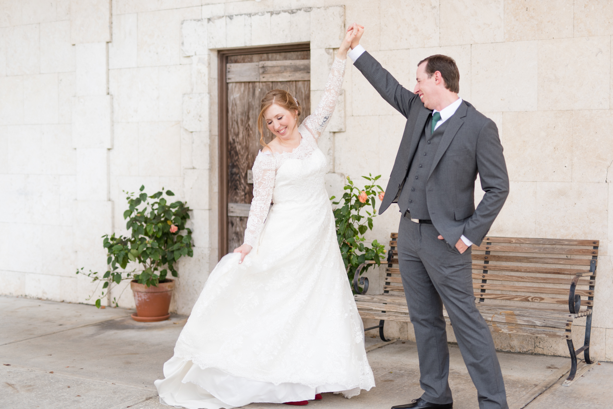 Groom twirls bride on wedding day.