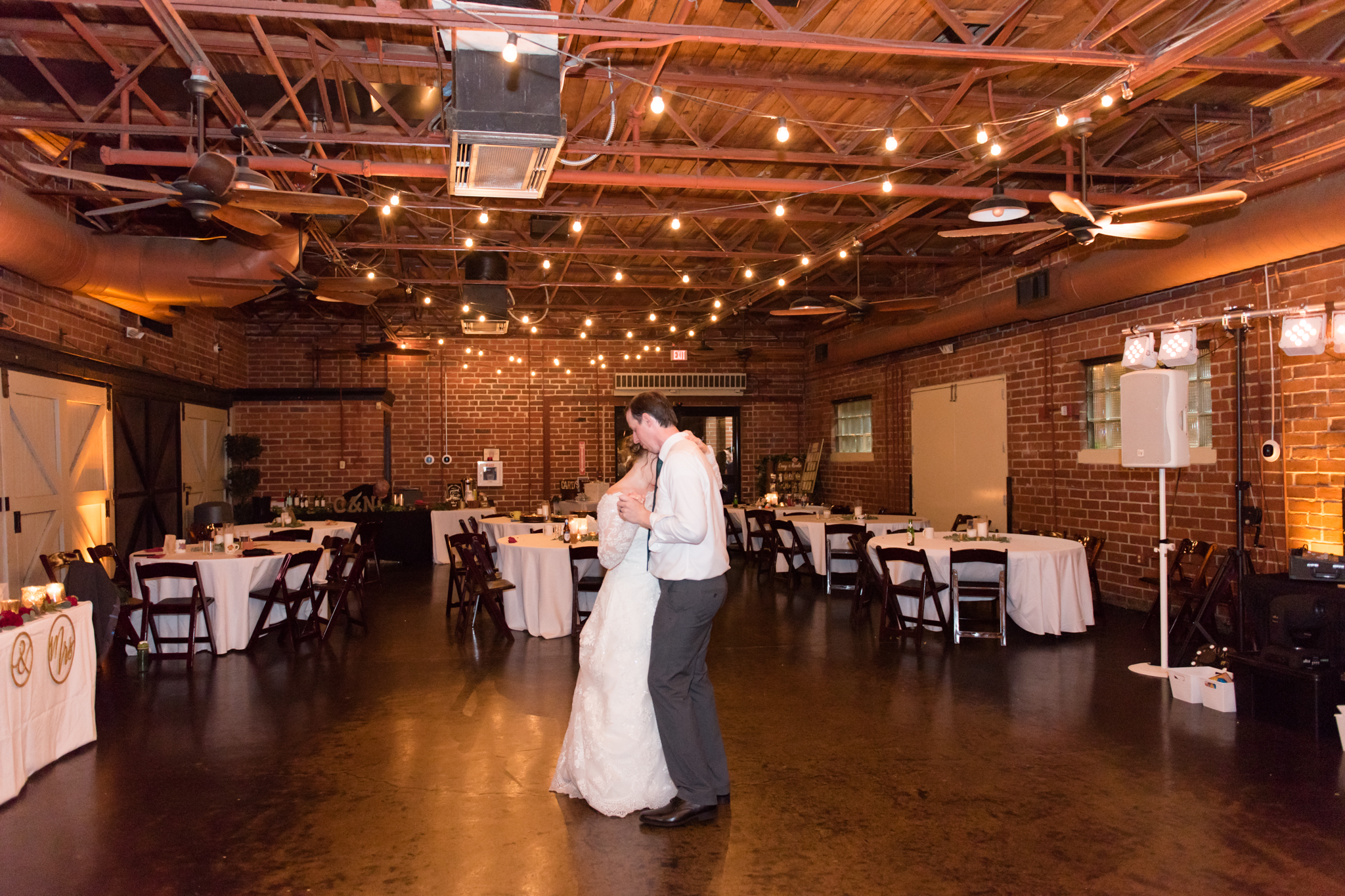 Bride and groom dance at end of wedding.