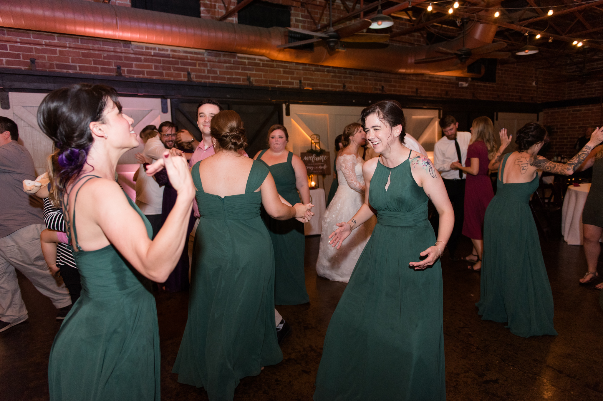 Bridesmaids dance at wedding reception.