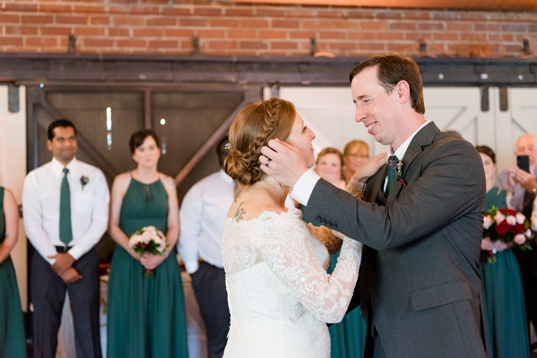 Groom looks lovingly at bride during dance.
