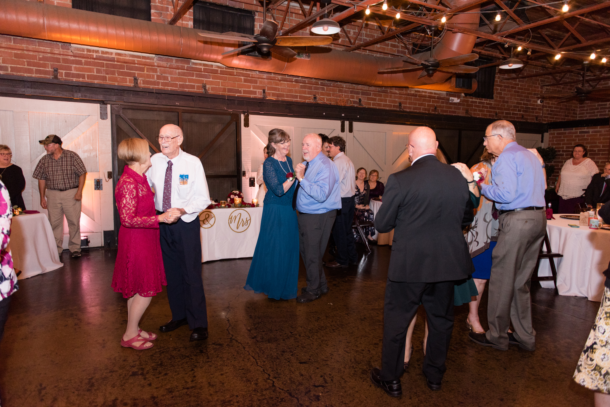 Couples dance at wedding reception.