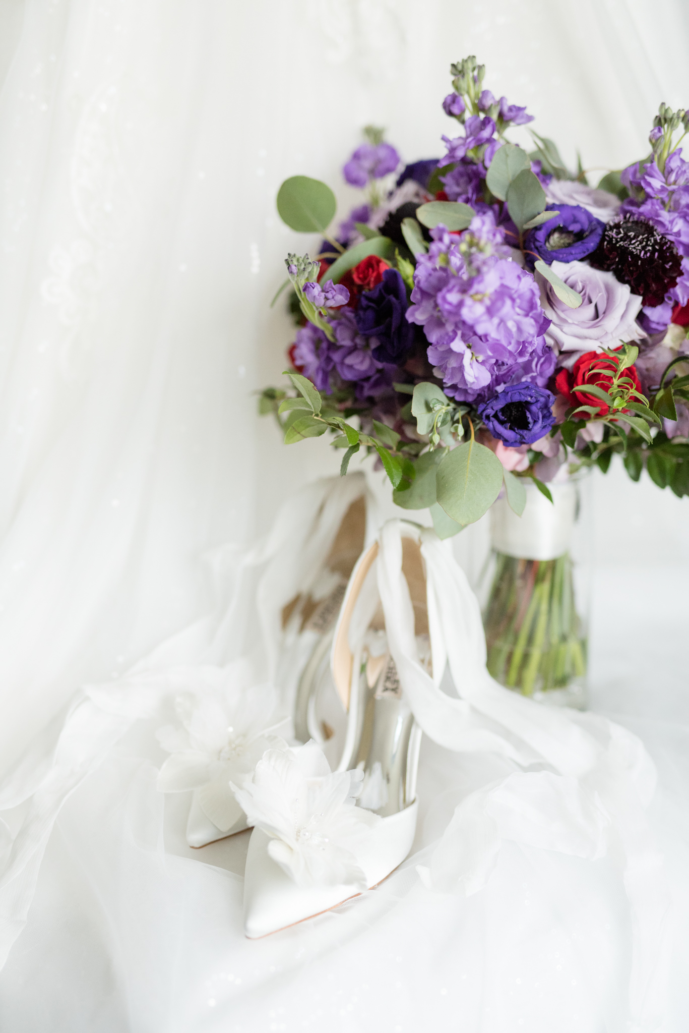 Bridal shoes sit with bouquet.