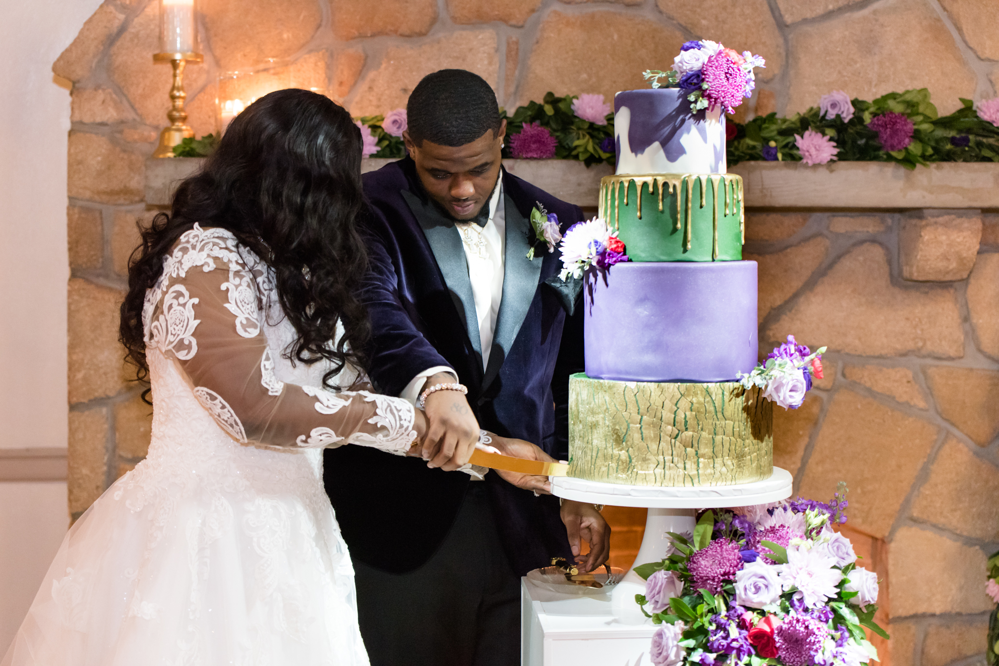 Bride and groom cut wedding cake.