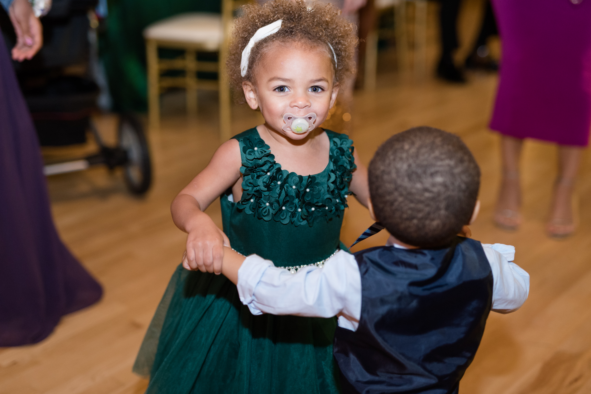 Little girl and boy dance at wedding reception.