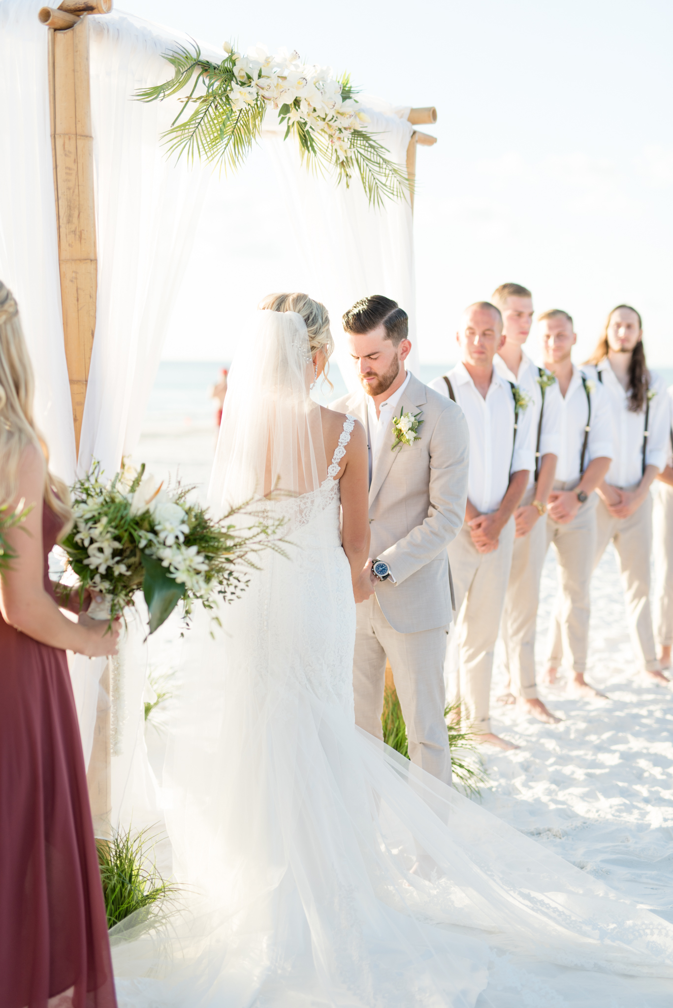 Bride and groom stand at altar.