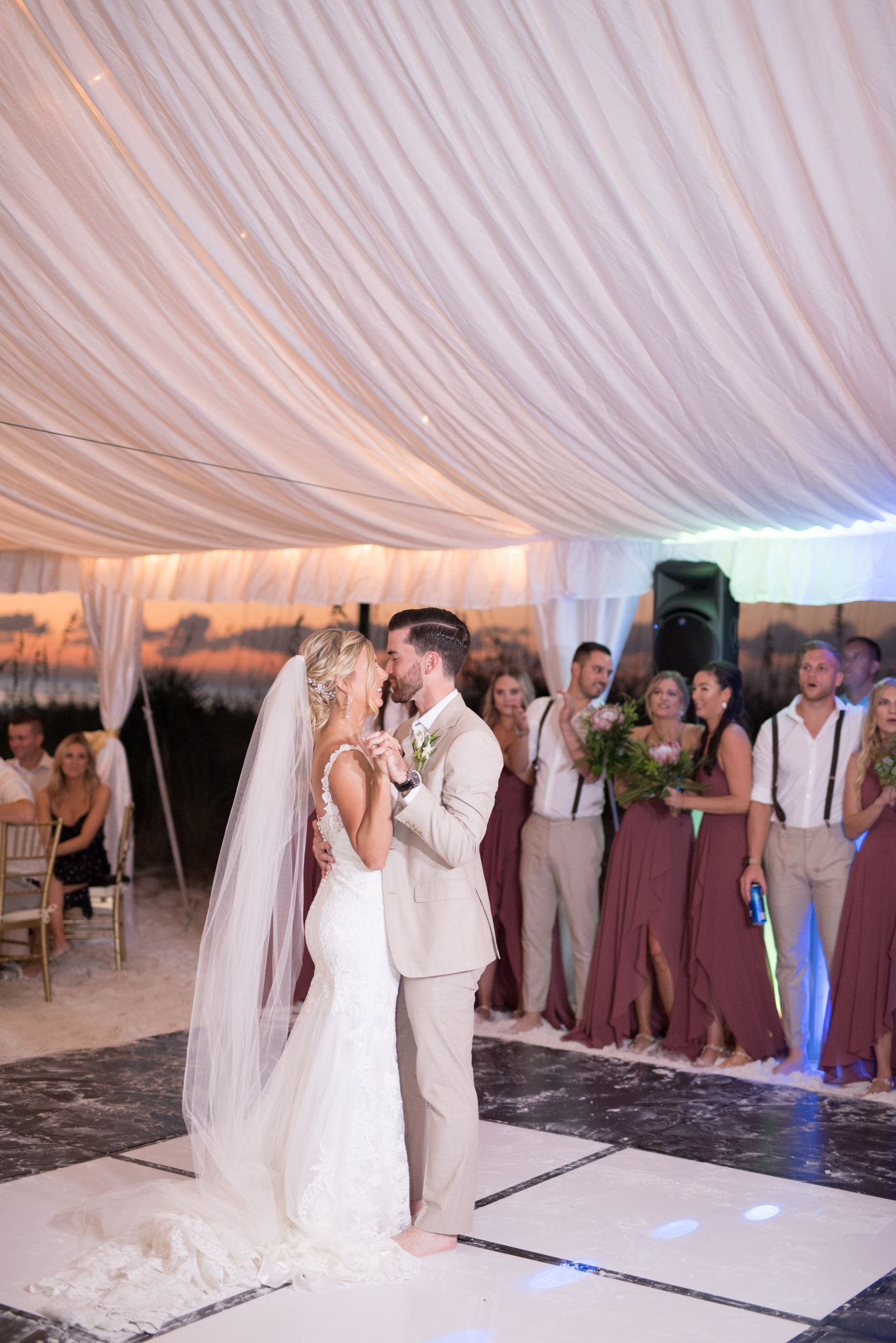 Bride and groom share first dance as married couple.
