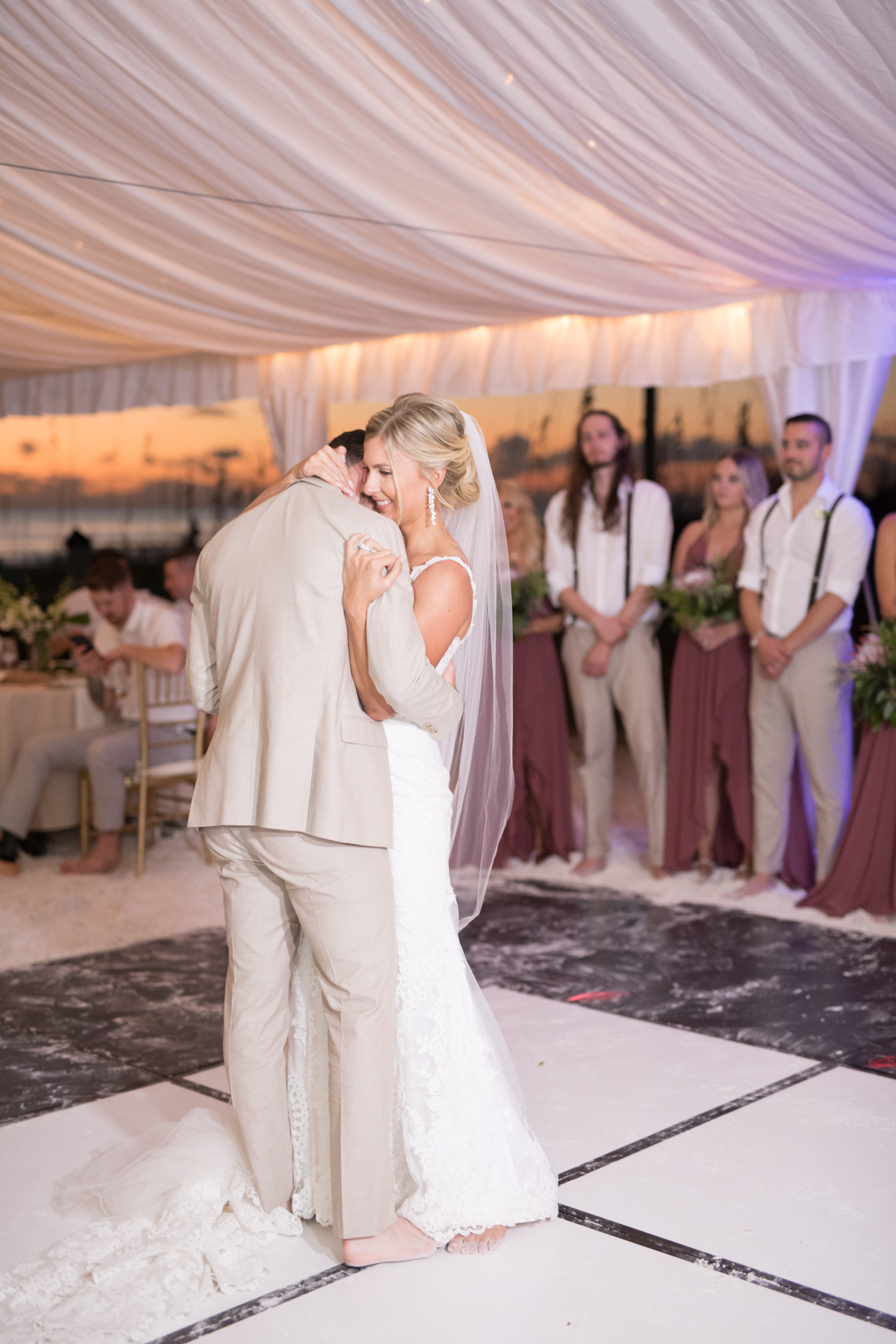 Bride and groom embrace during first dance.