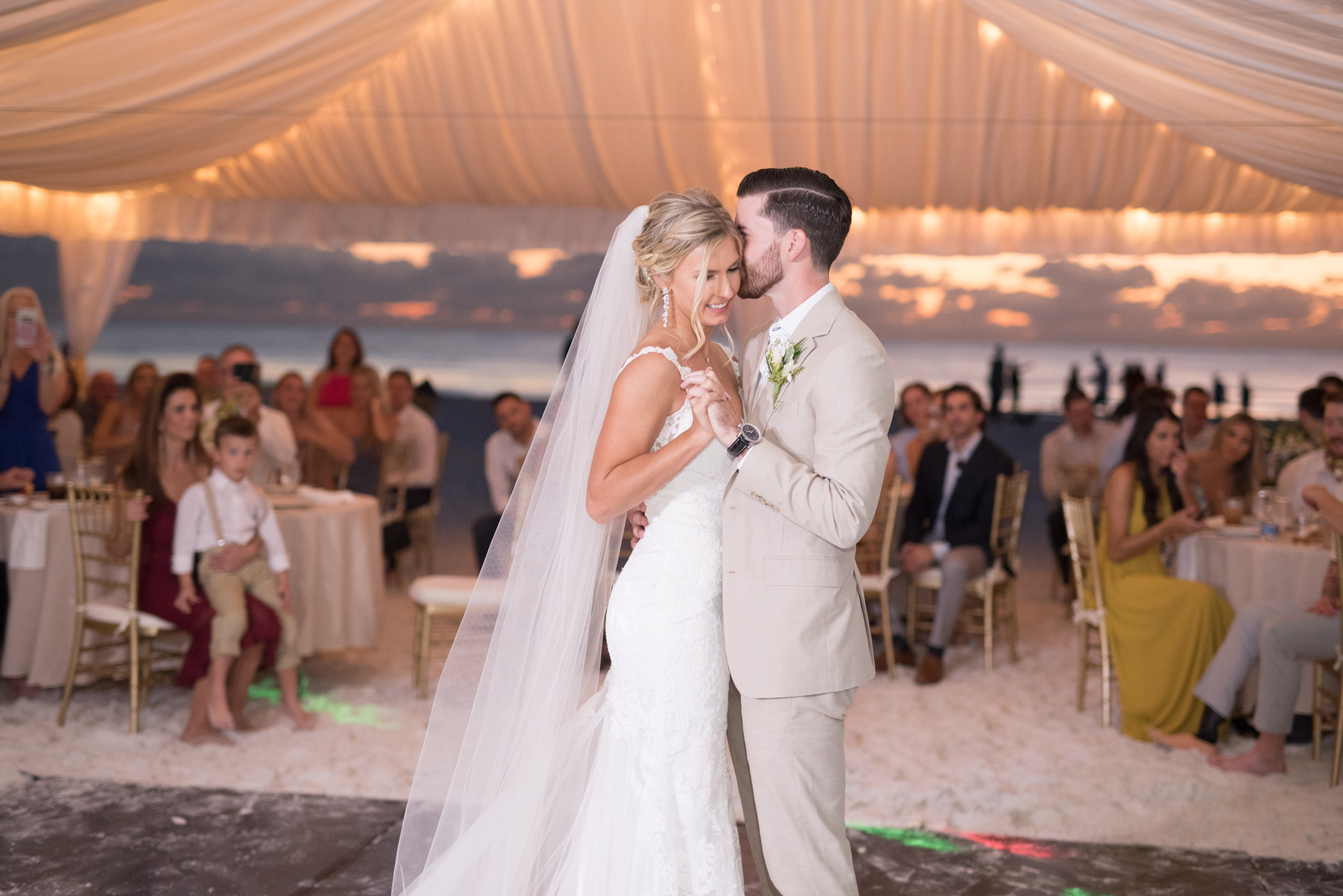 Bride and groom laugh during first dance.