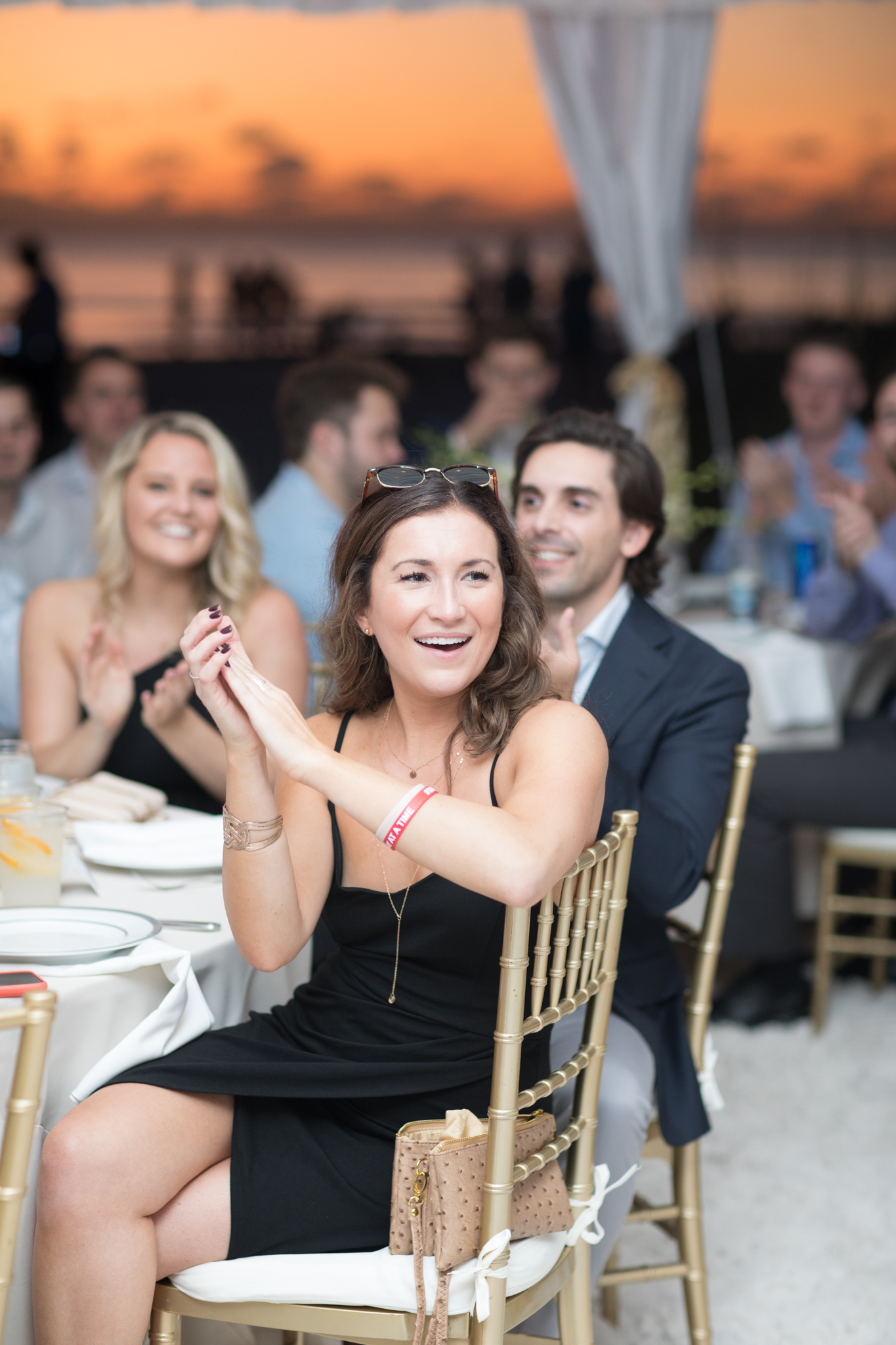 Wedding guests clap.