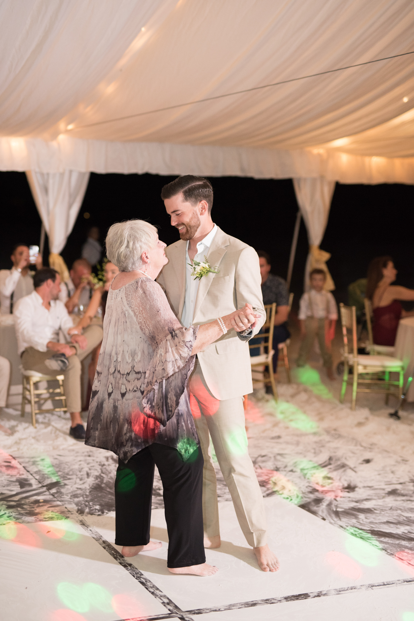 Groom and grandmother dance together.