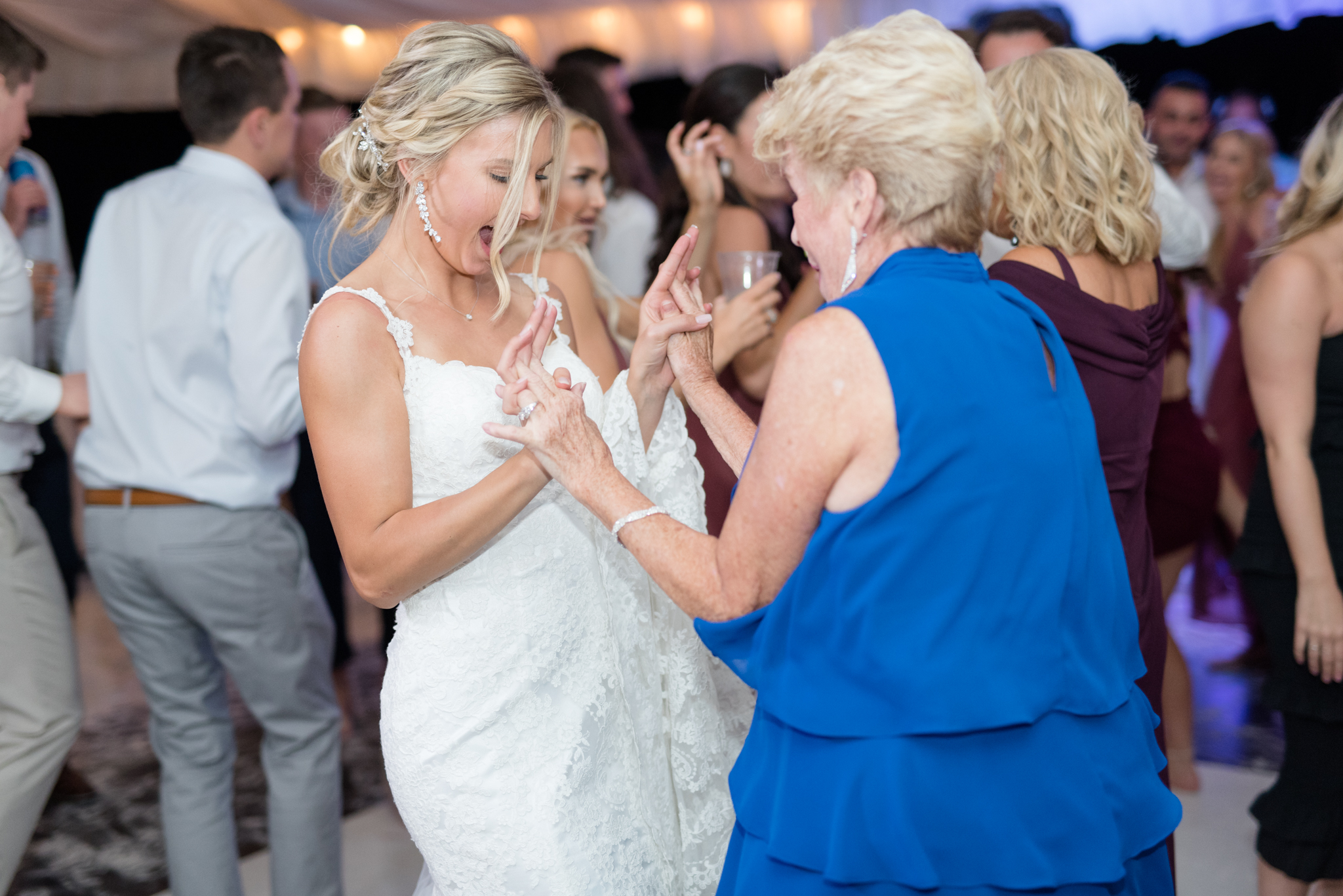 Bride and grandmother dance together.