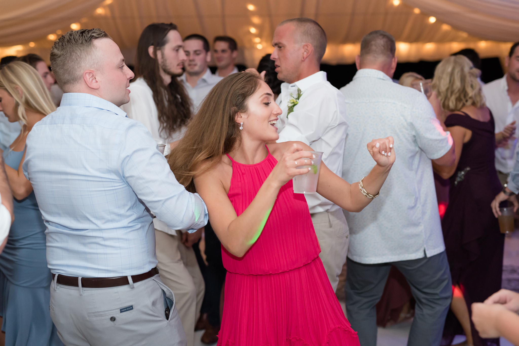 Guests dance at wedding reception.