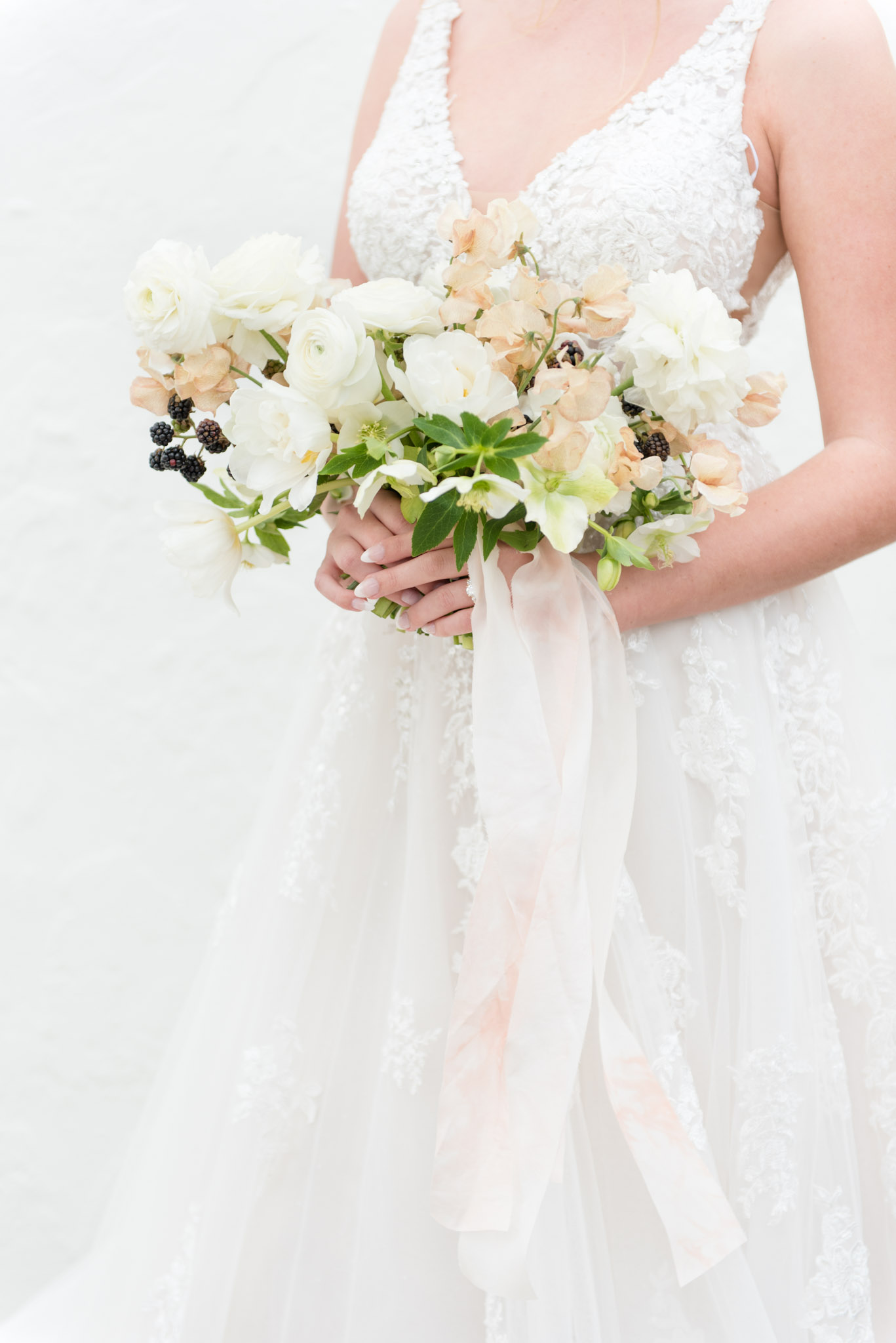 Bride hold wedding flowers.