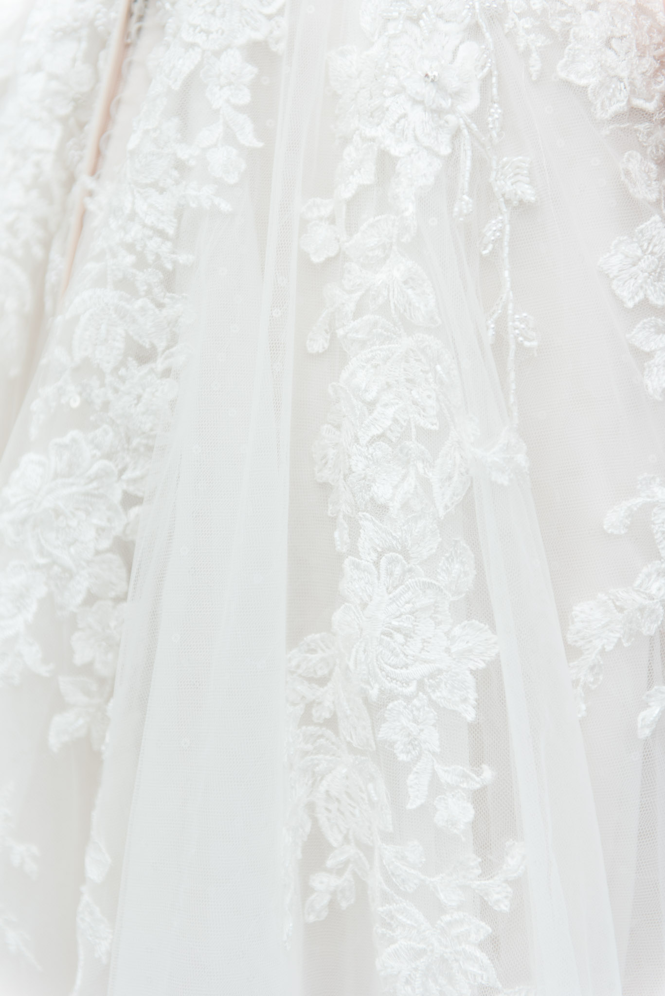 Lace on bride's wedding dress.