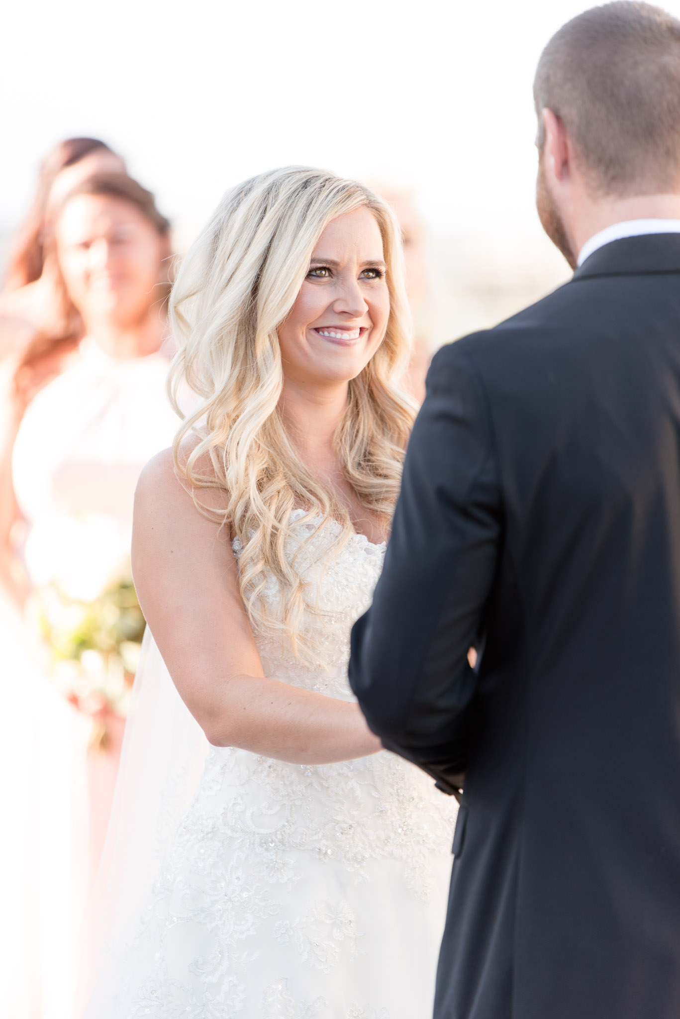 Bride smiles during wedding ceremony.