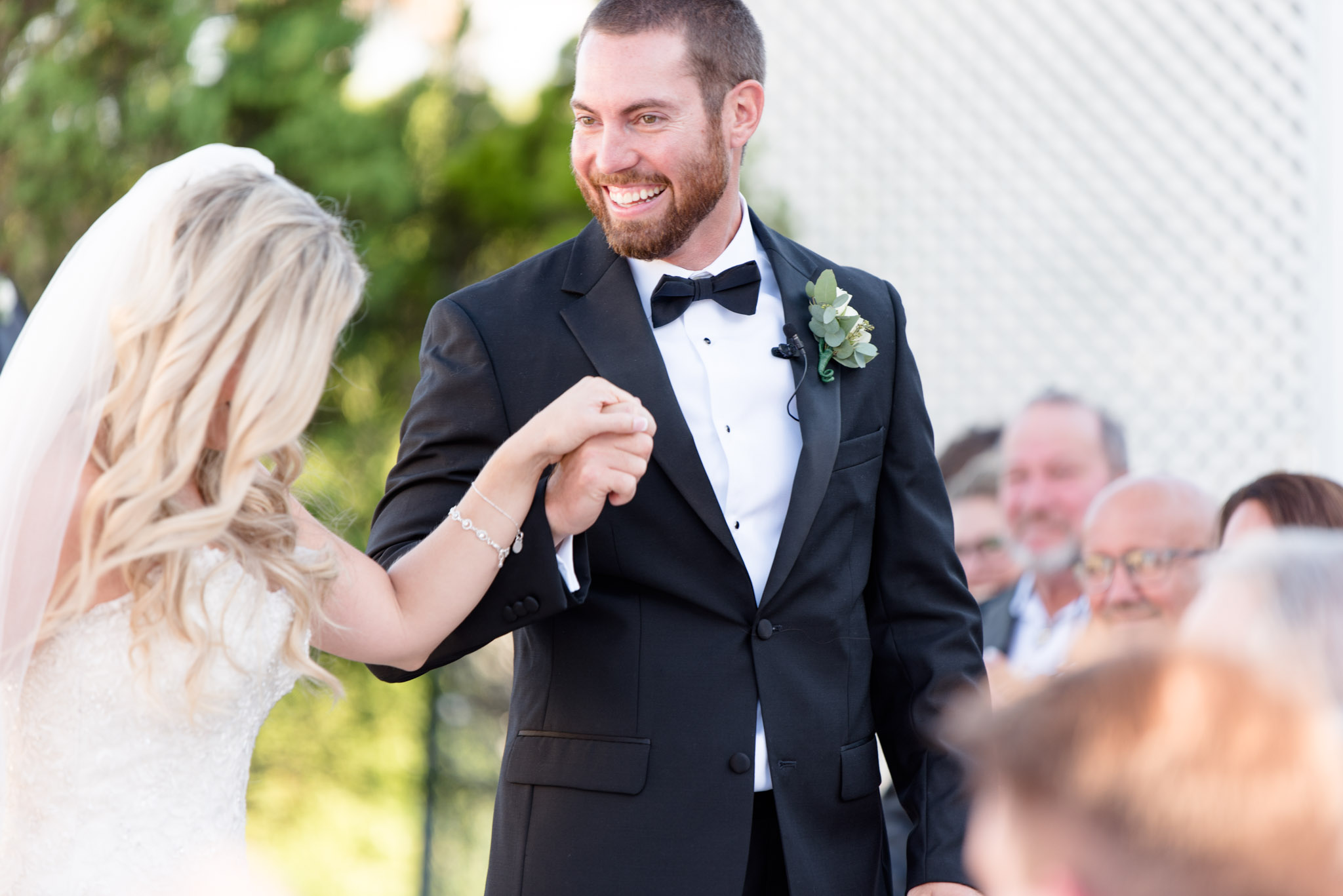 Groom smiles as couple walks back down aisle.