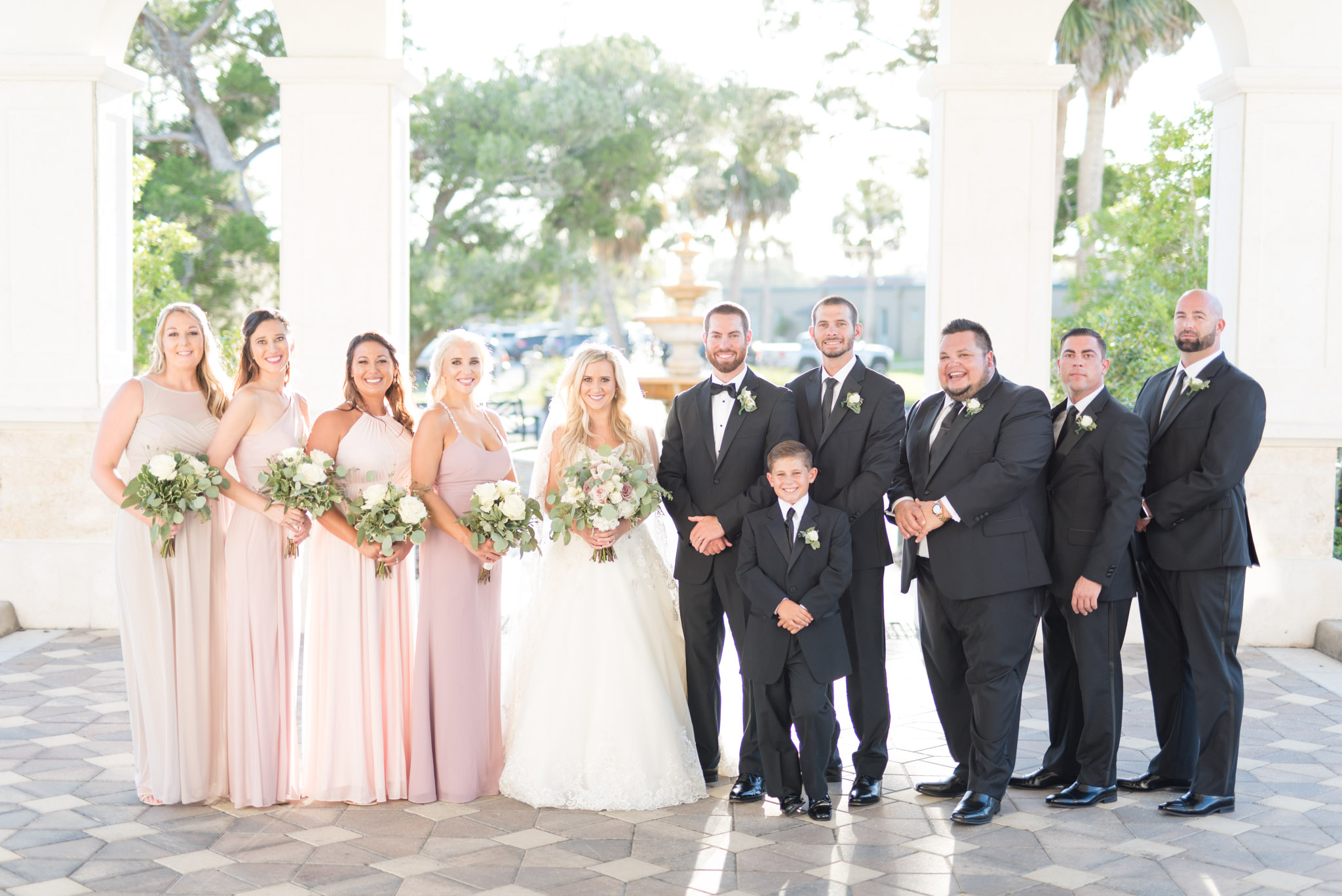 Wedding party smiles at camera.