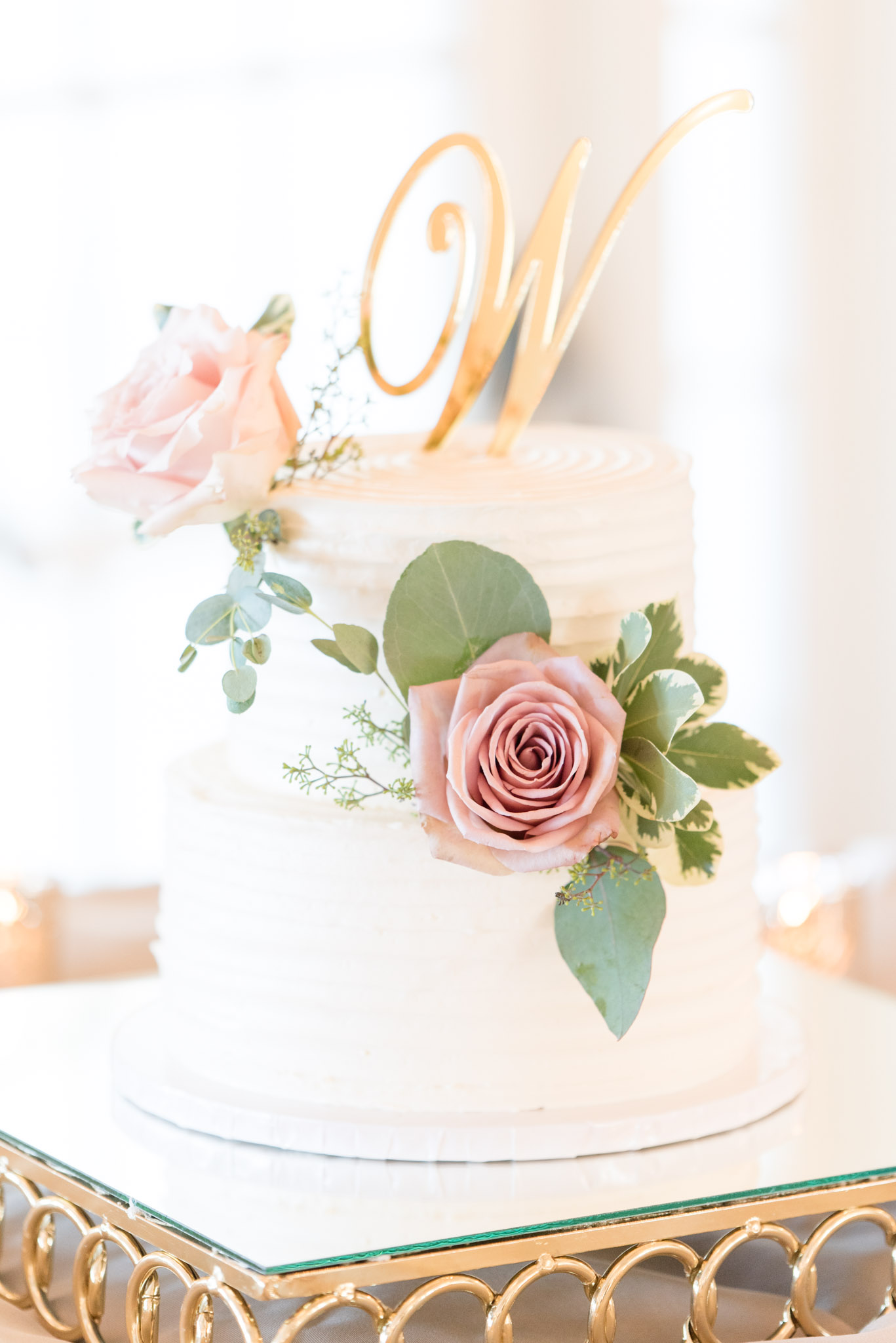 White and blush wedding cake.