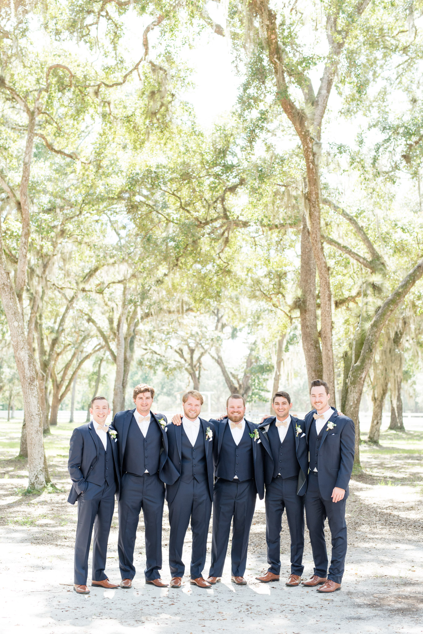 Groomsmen smile at the camera.