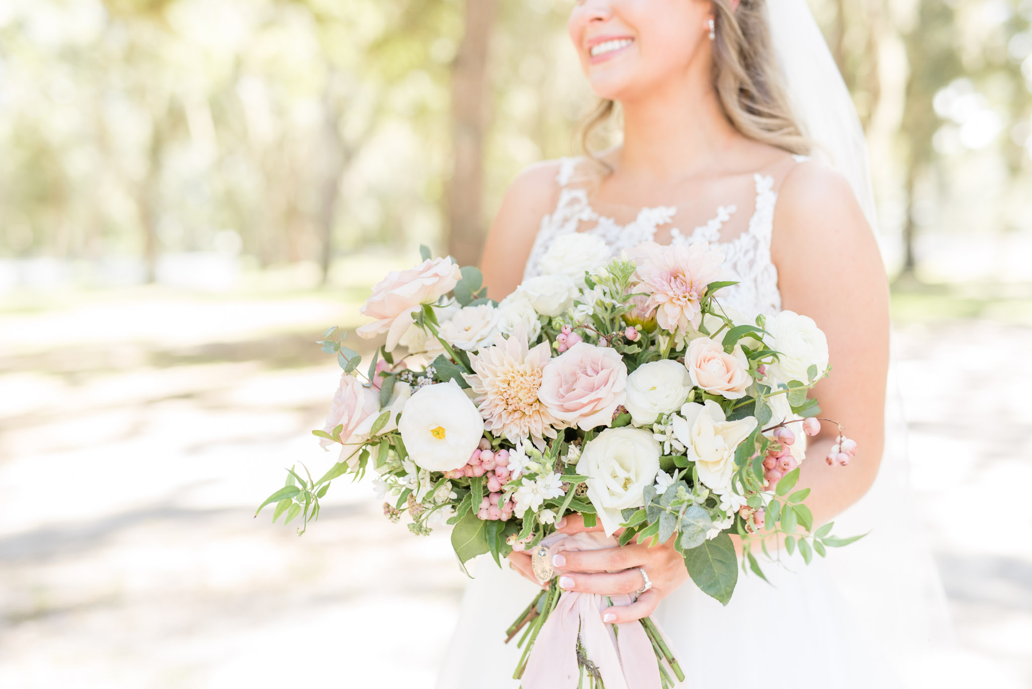 Bride holds flowers on wedding day.