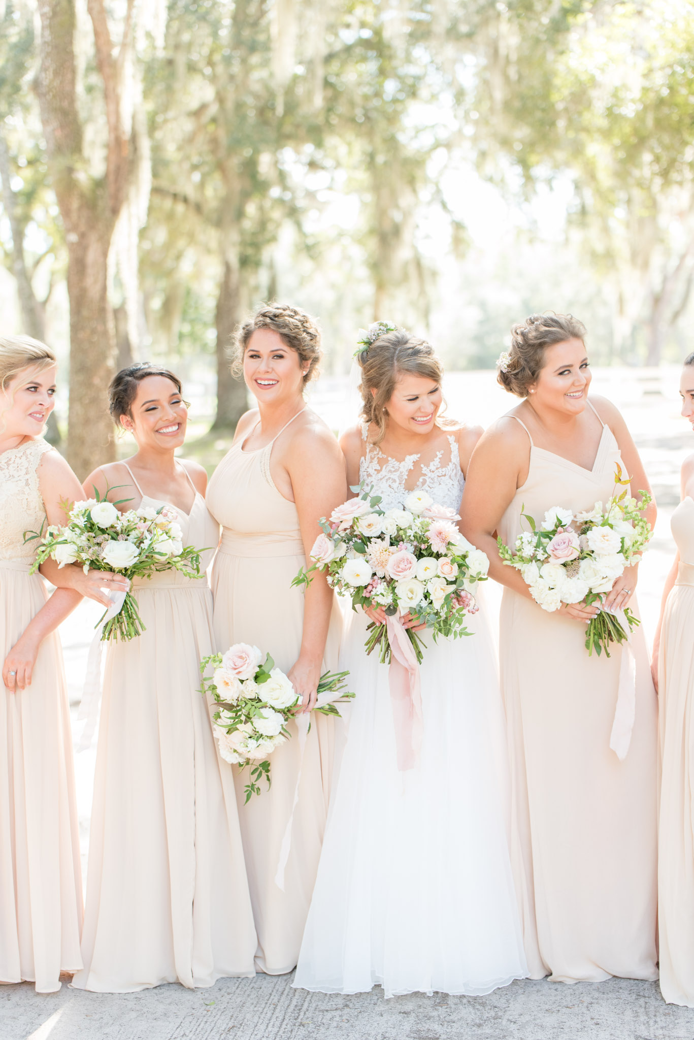 Bride and bridesmaids giggle together.