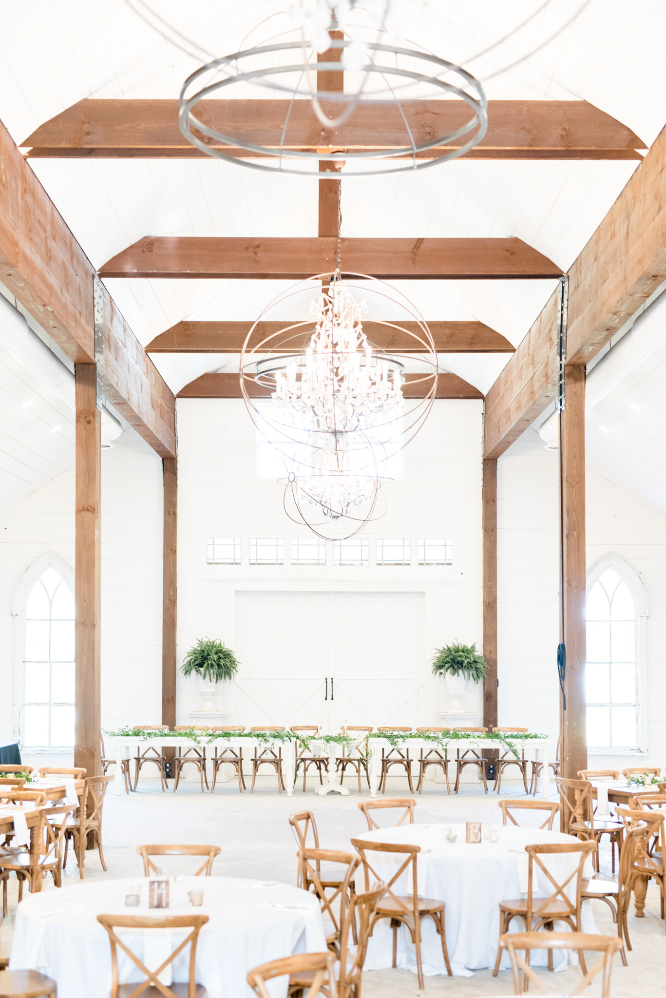 White reception with wood beams.