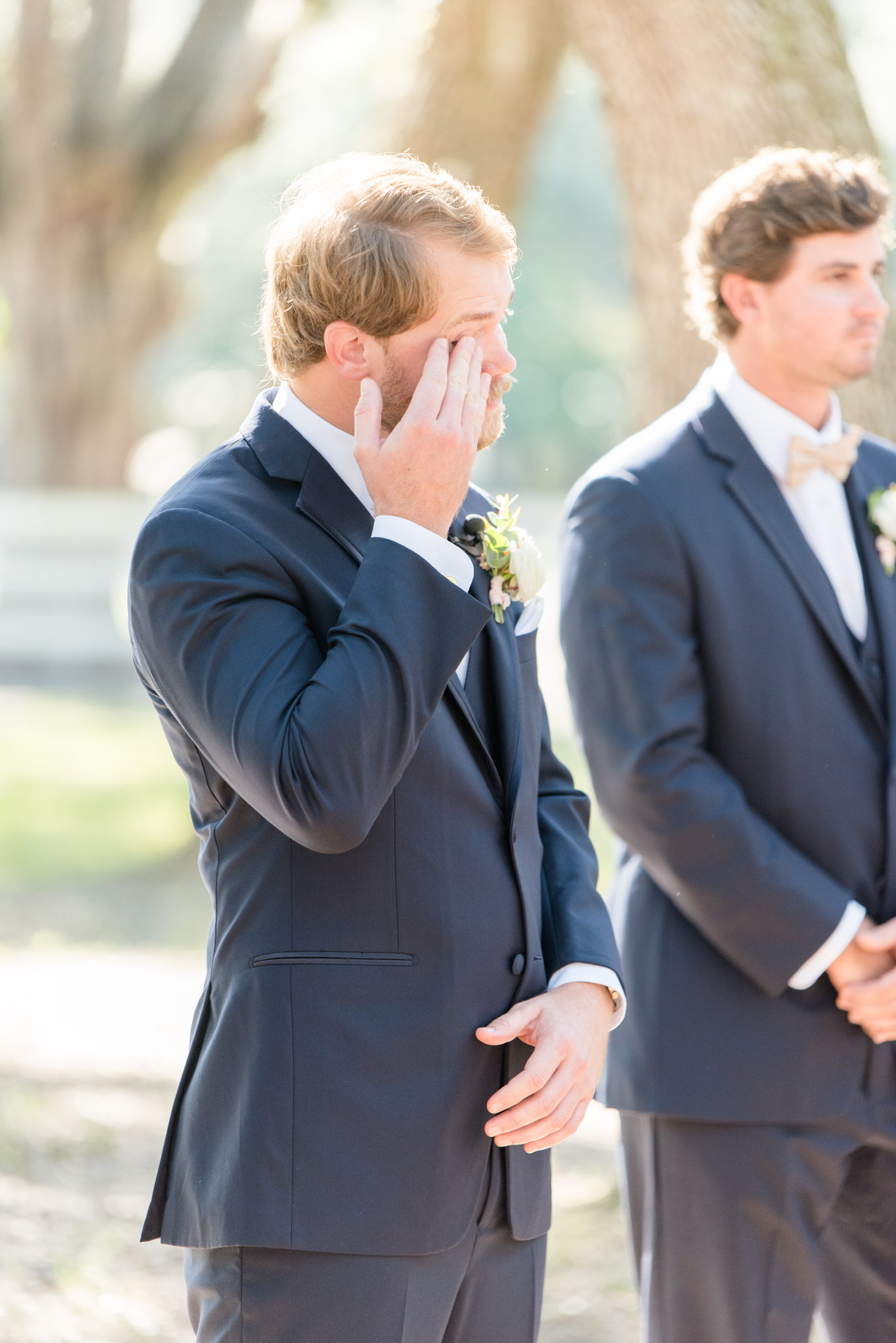 Groom cries as bride comes down aisle.