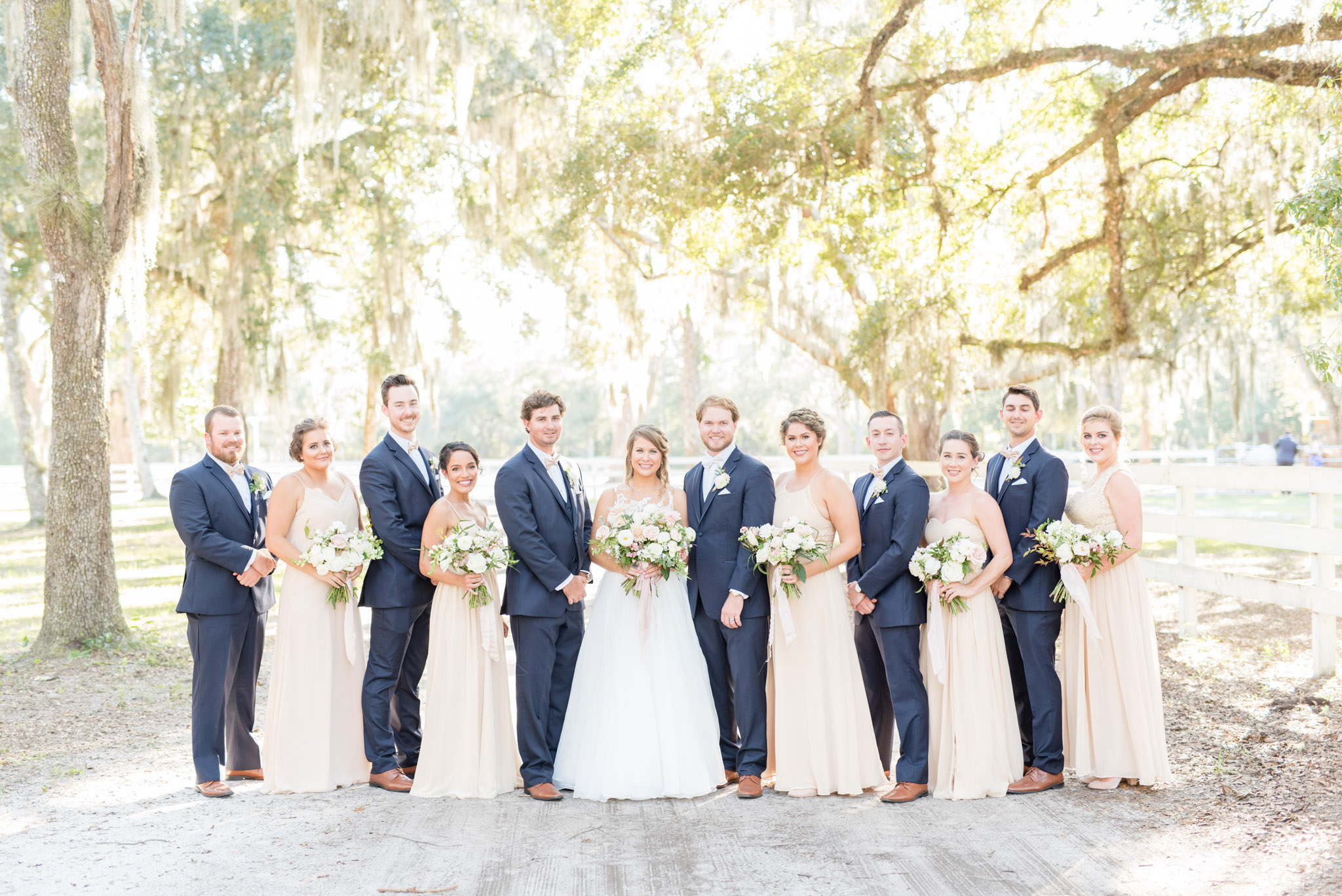 Wedding party smiles at camera.