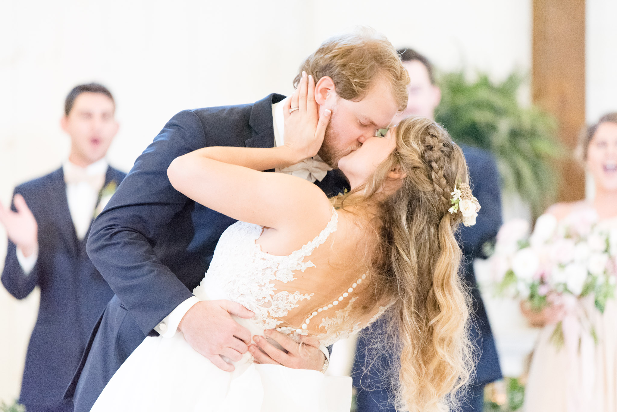 Groom dips bride during first dance.