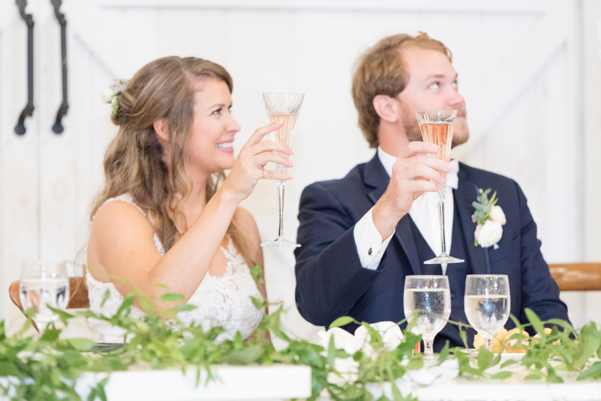 Bride and groom raise toast.