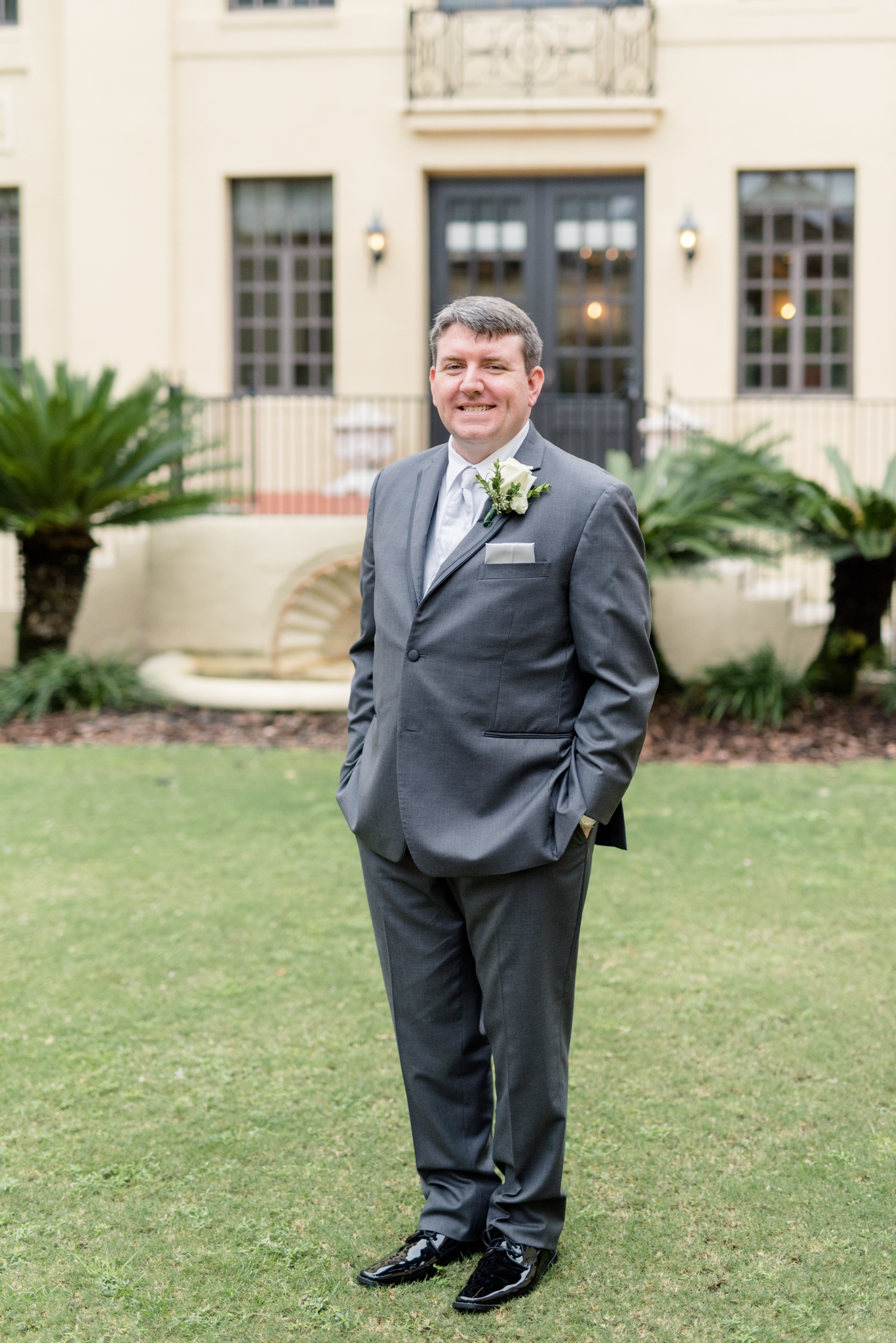 Groom smiles at camera.