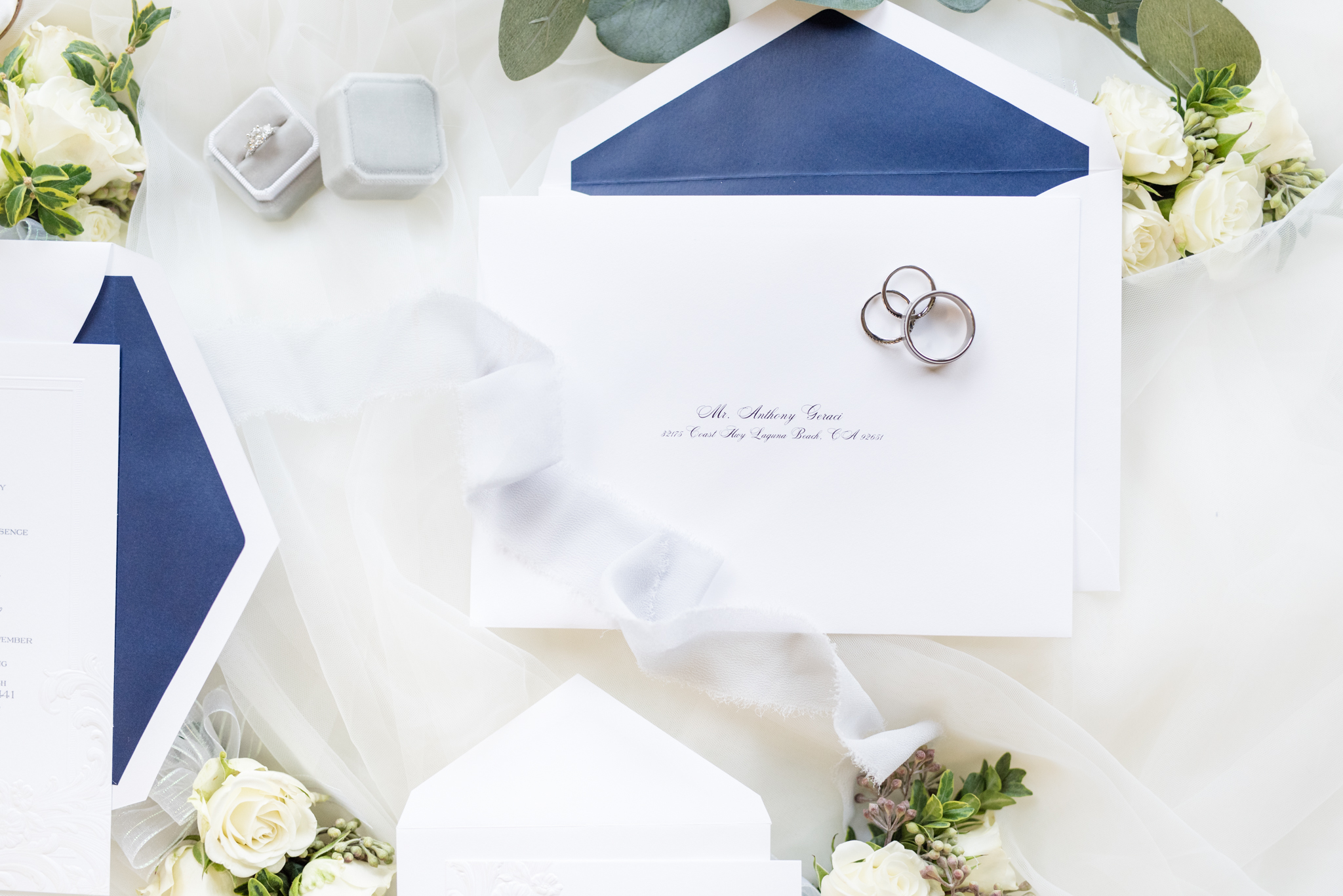Wedding invitations and rings.
