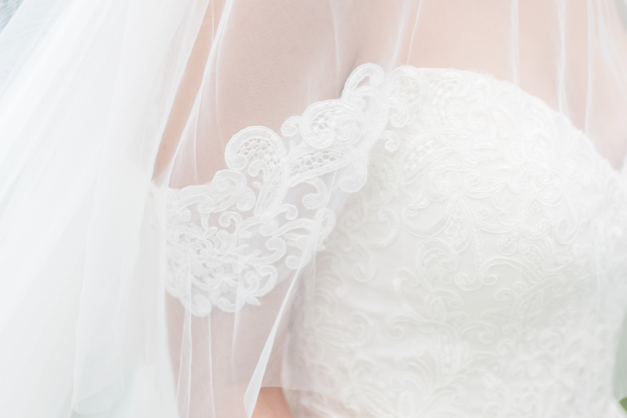 Lace on wedding gown sleeves.