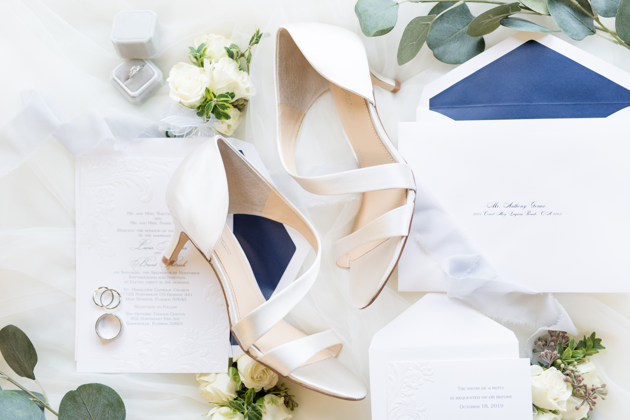 Bride's shoes sits with invitations.