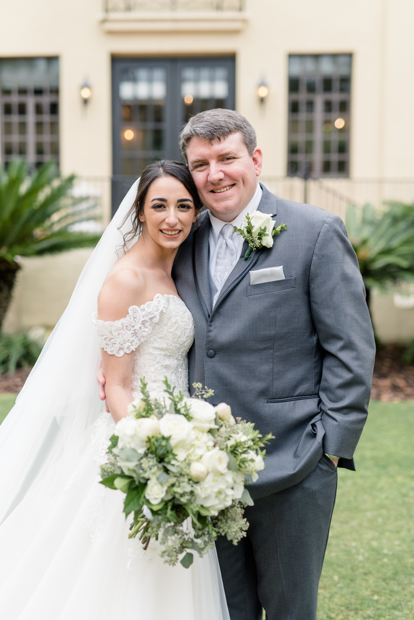 Bride and groom smile at camera.