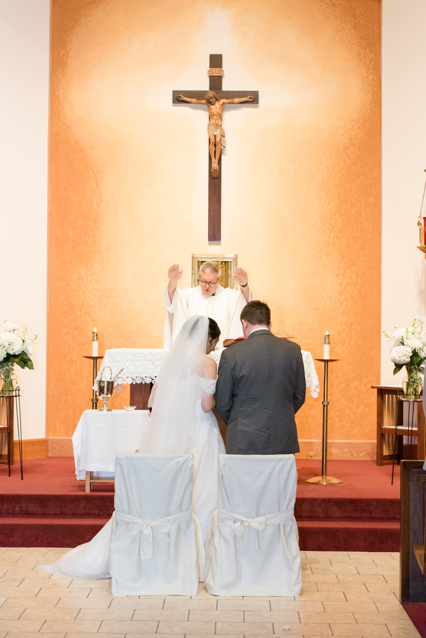 Bride and groom pray at wedding ceremony.