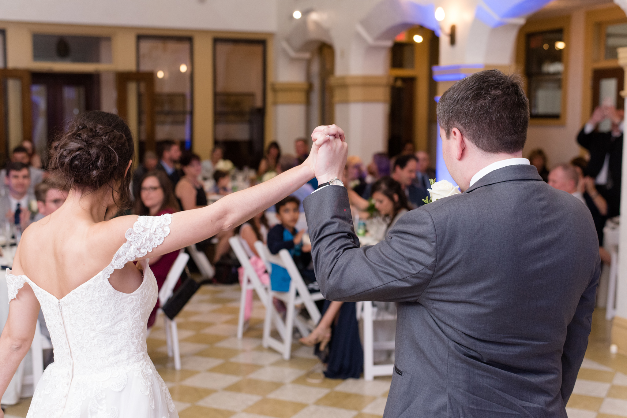 bride and groom cheer at reception
