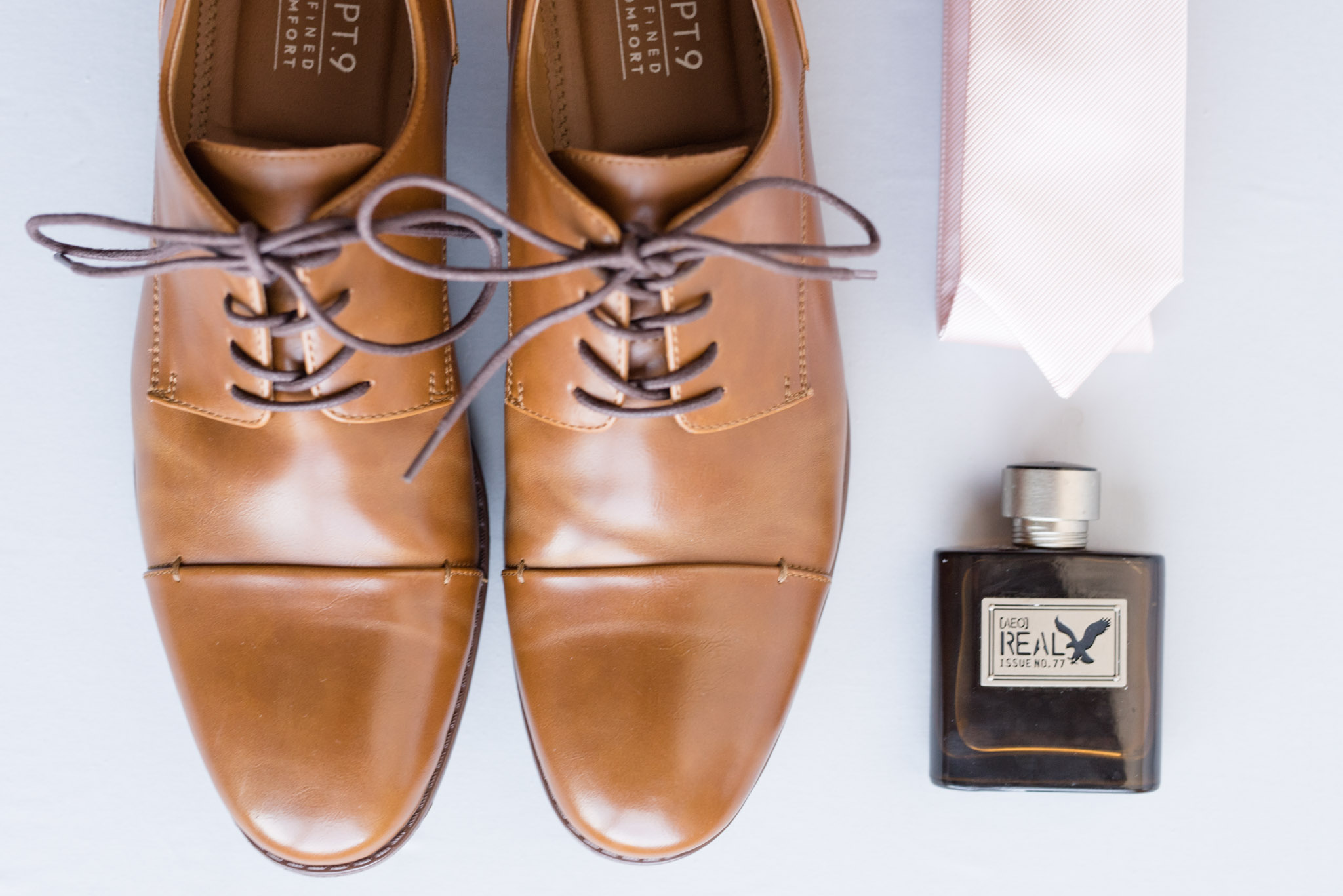Groom's shoes, tie, and cologne.