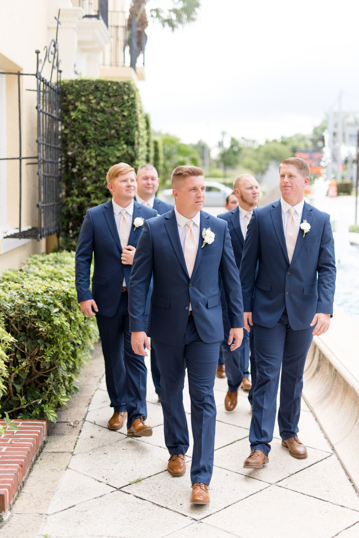 Groom walks with groomsmen.
