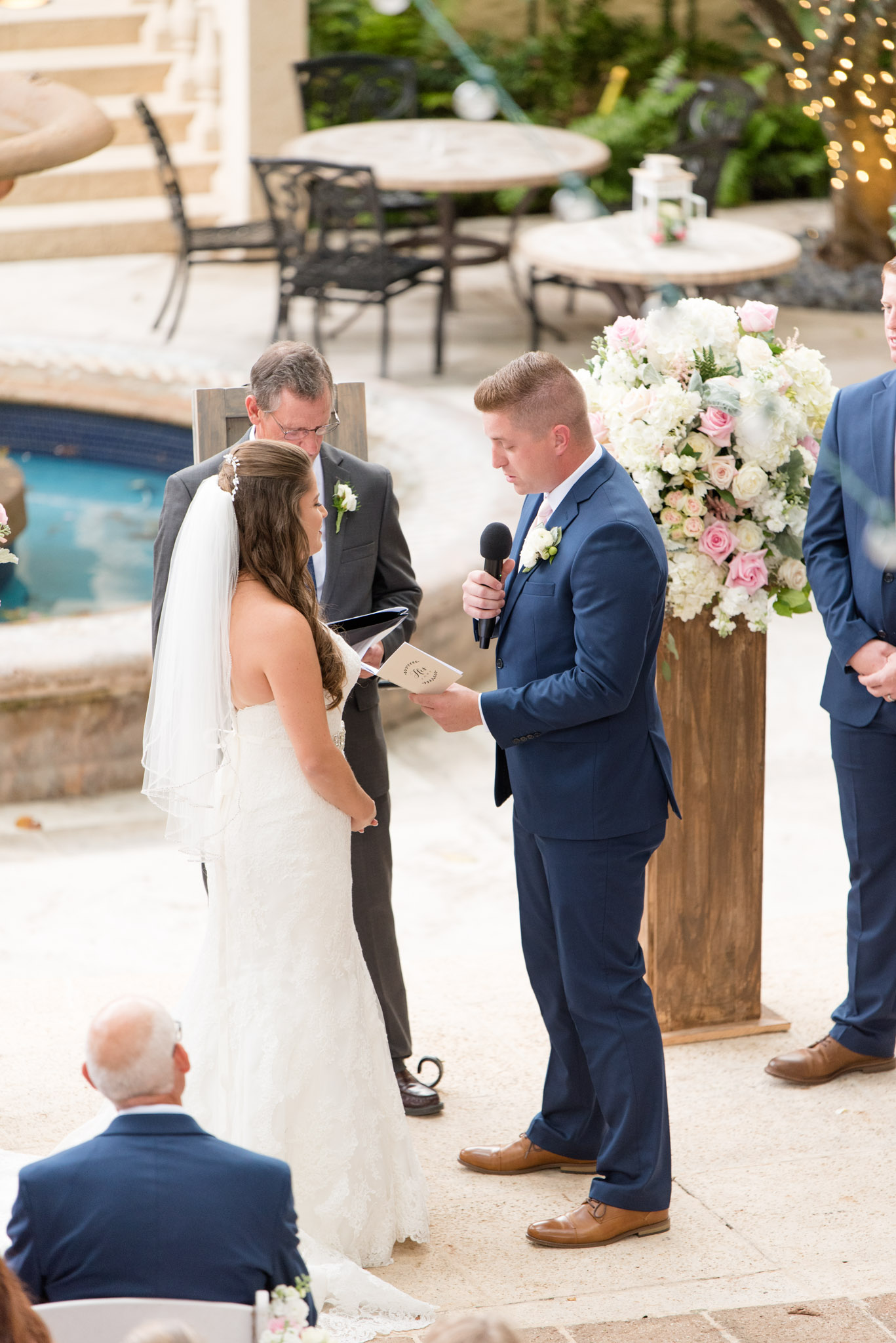 Groom reads vows to bride during ceremony.