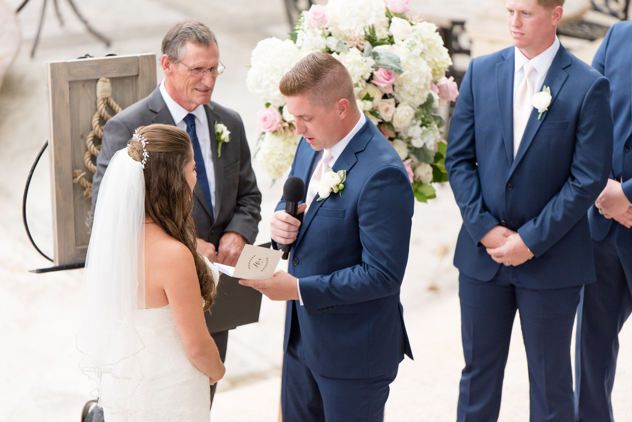 Groom reads vows to bride.