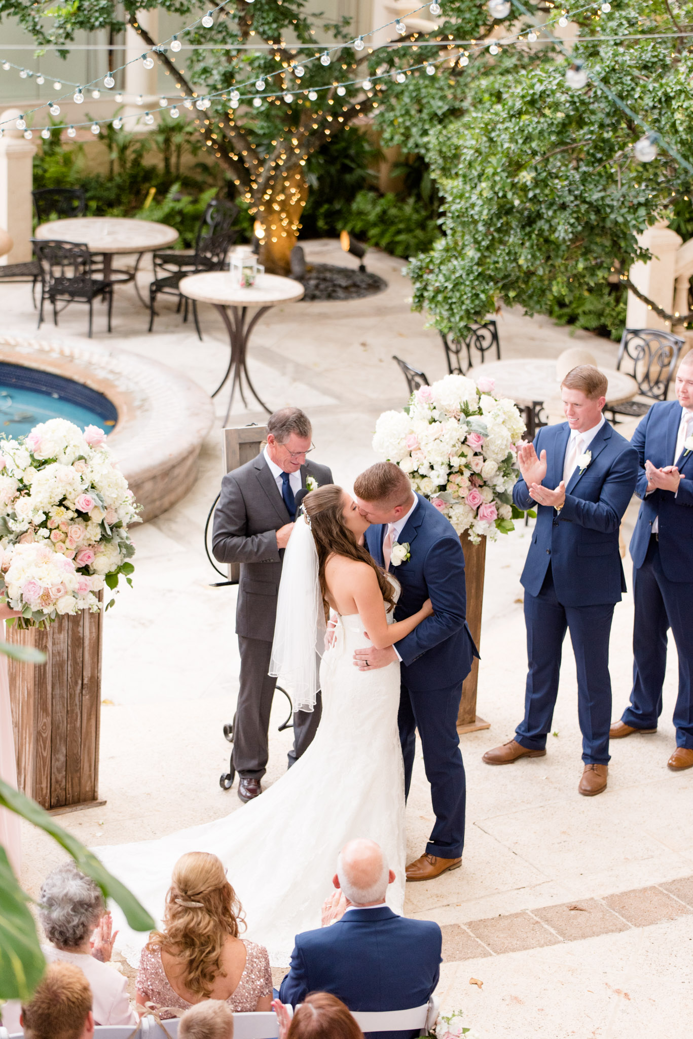 Bride and groom share first kiss as married couple.