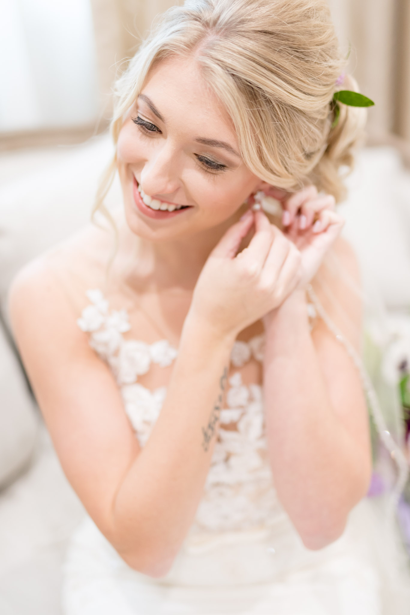Bride puts on earring.