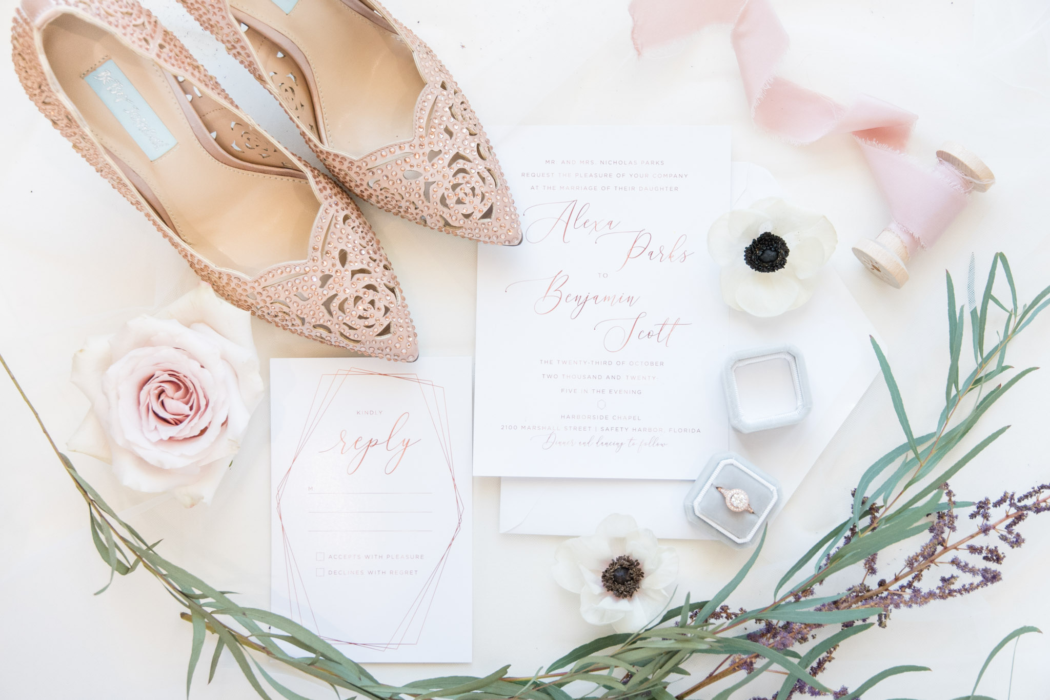 Wedding invitations with shoes and flowers.
