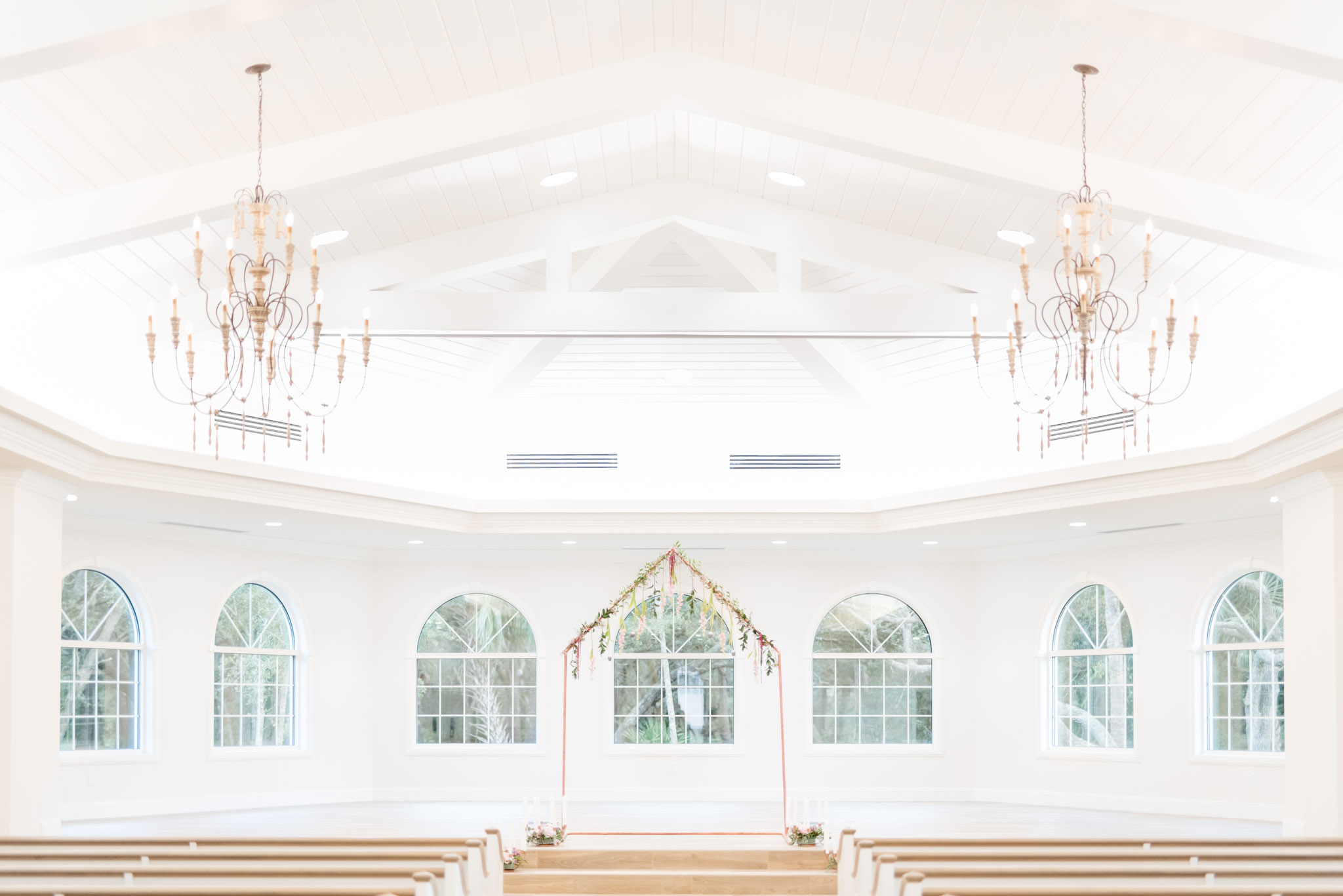 White chapel with chandeliers.