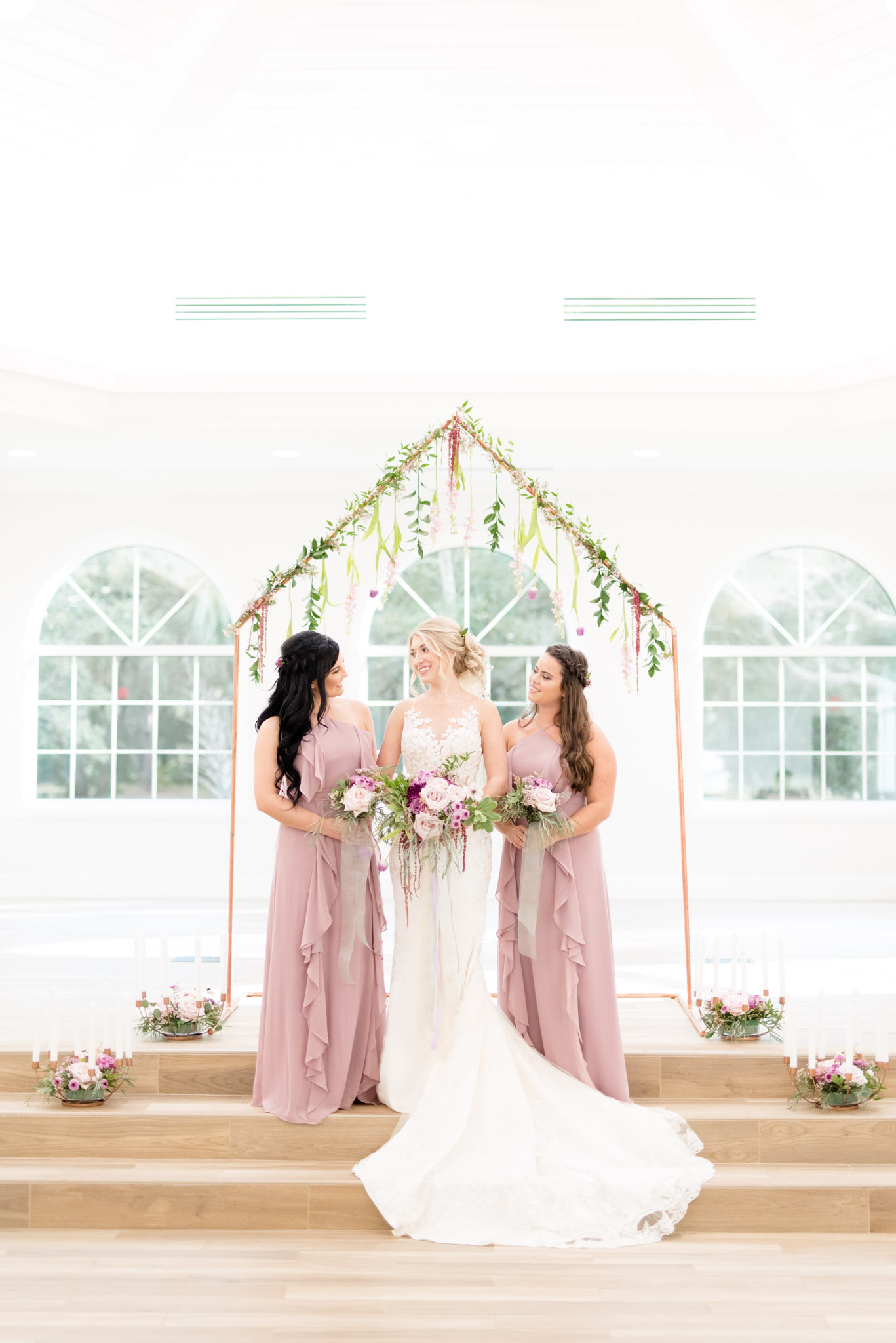Bride and bridesmaid's laugh together.