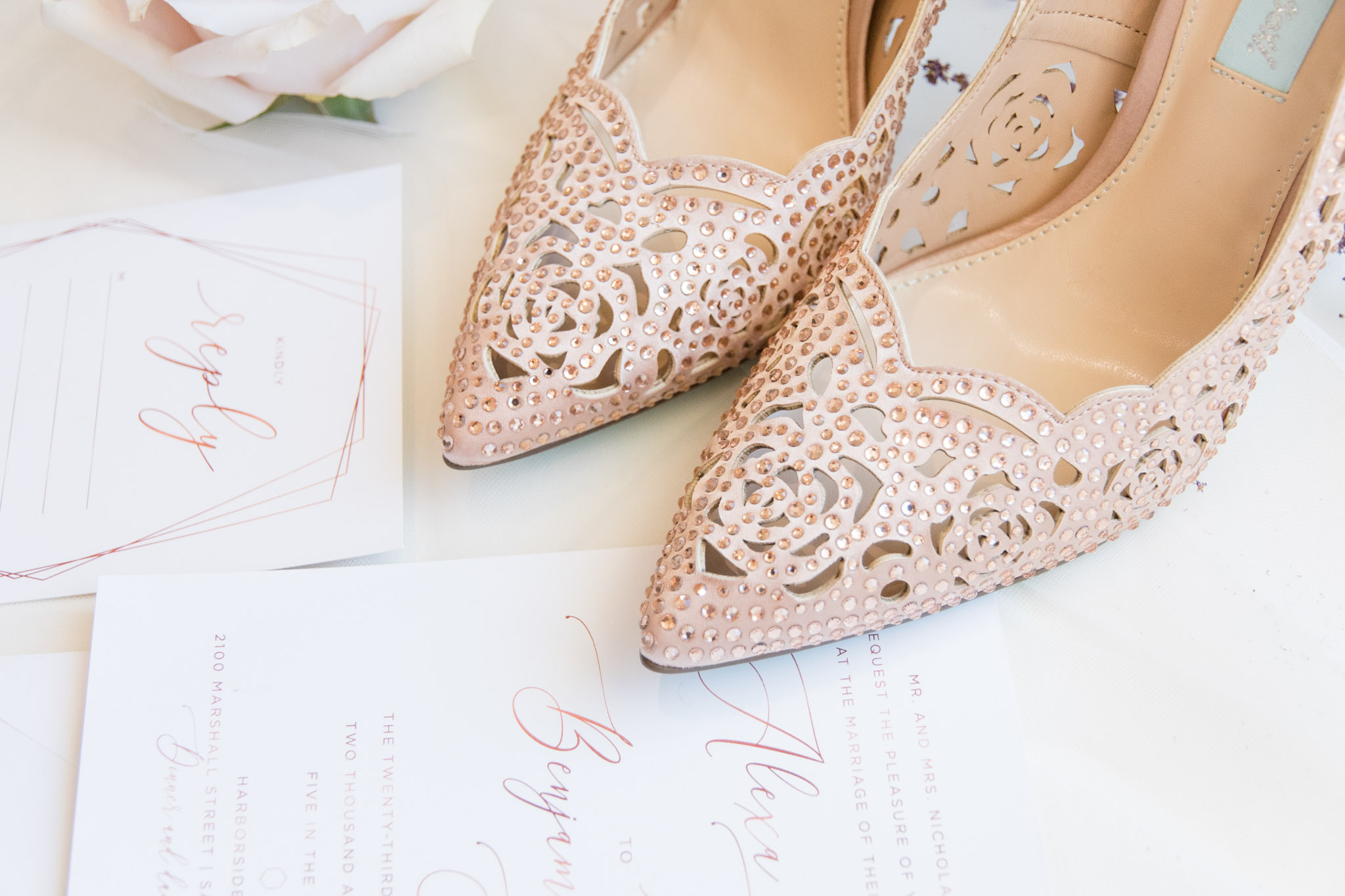Bride's shoes along with wedding invitations.