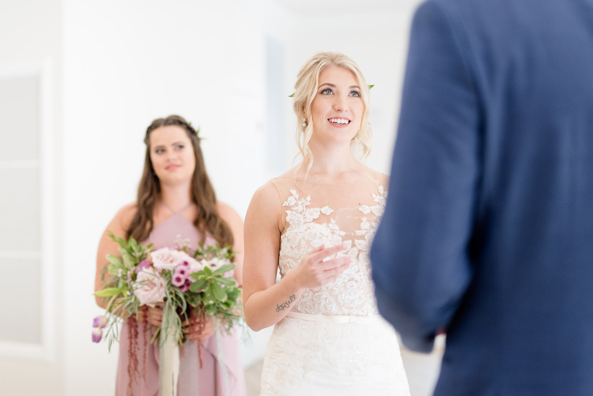 Bride smiles at groom during ceremony.
