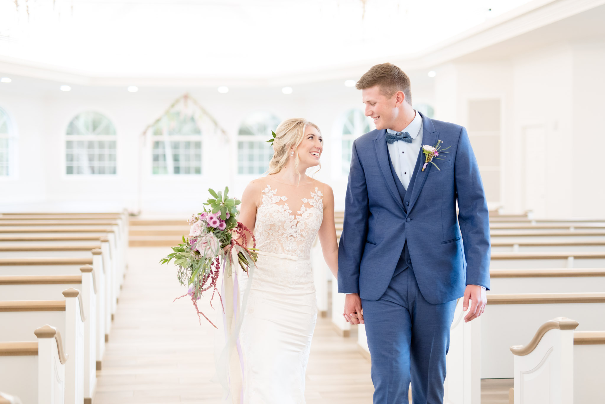 Bride and groom walk down aisle after ceremony.