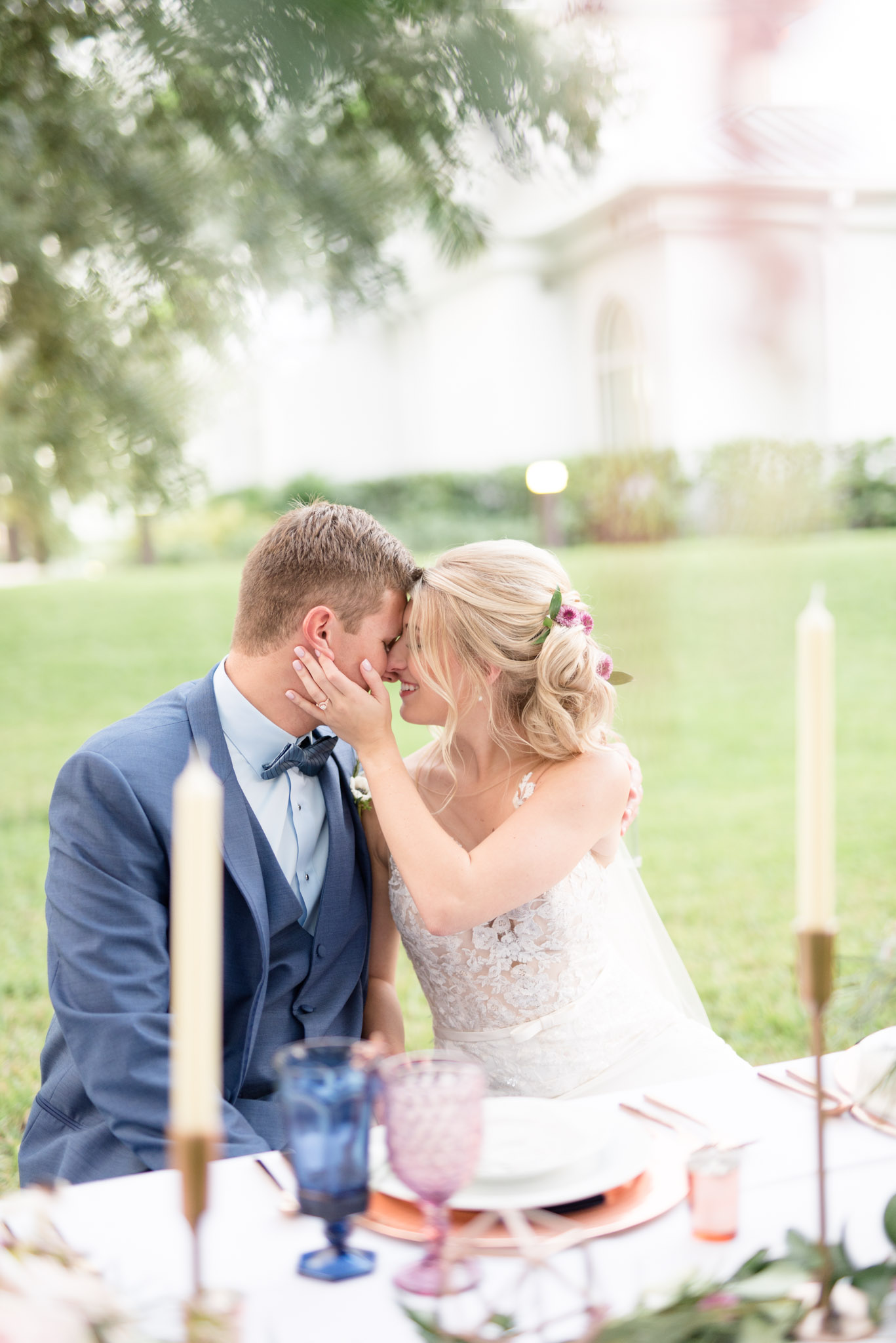 bride and groom lean in for kiss at reception